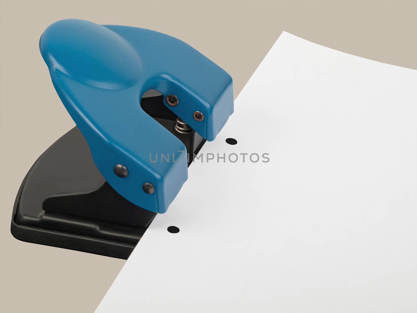 drilling hole punch with paper, studio shot