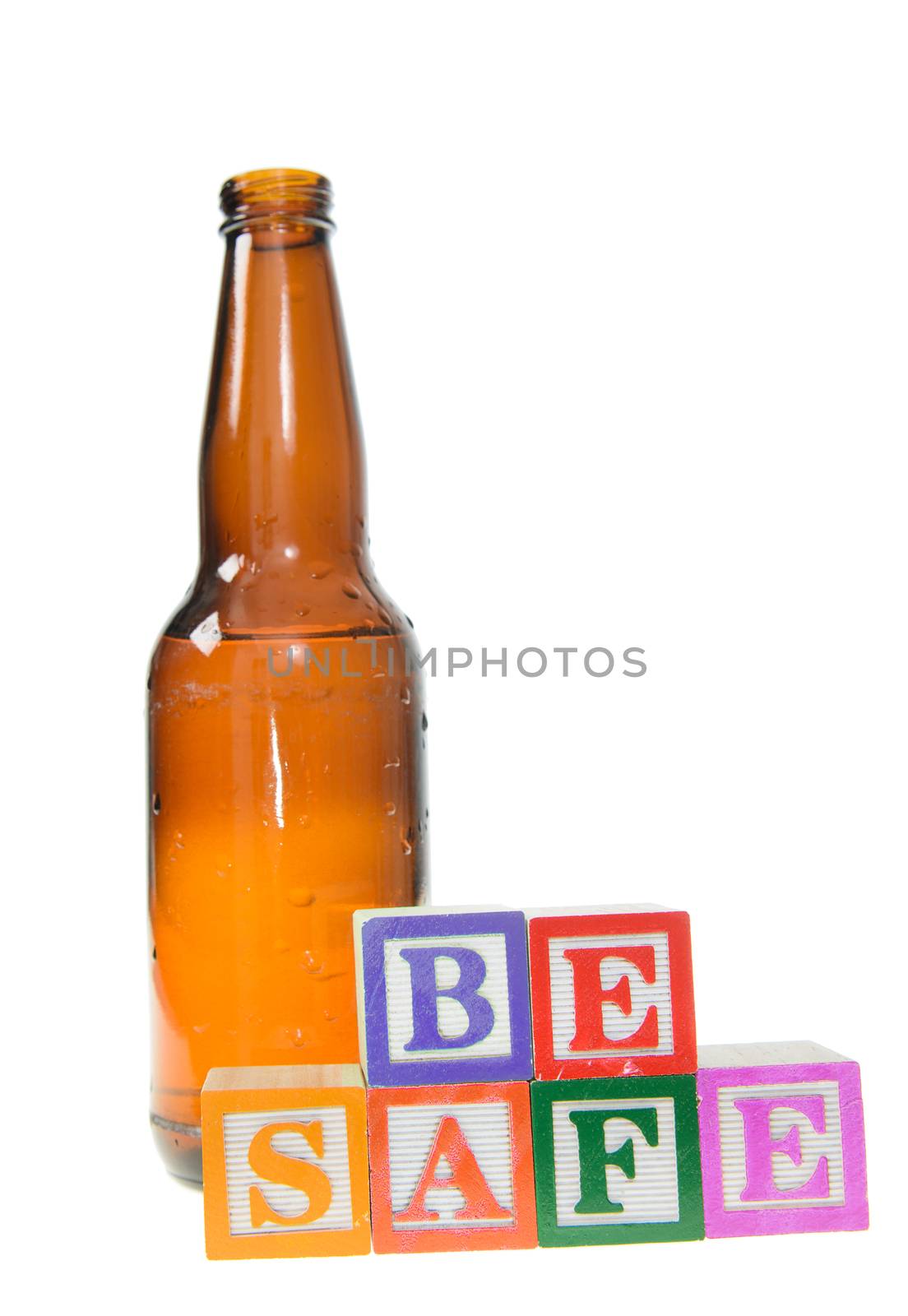 Letter blocks spelling be safe with a beer bottle. Isolated on a white background