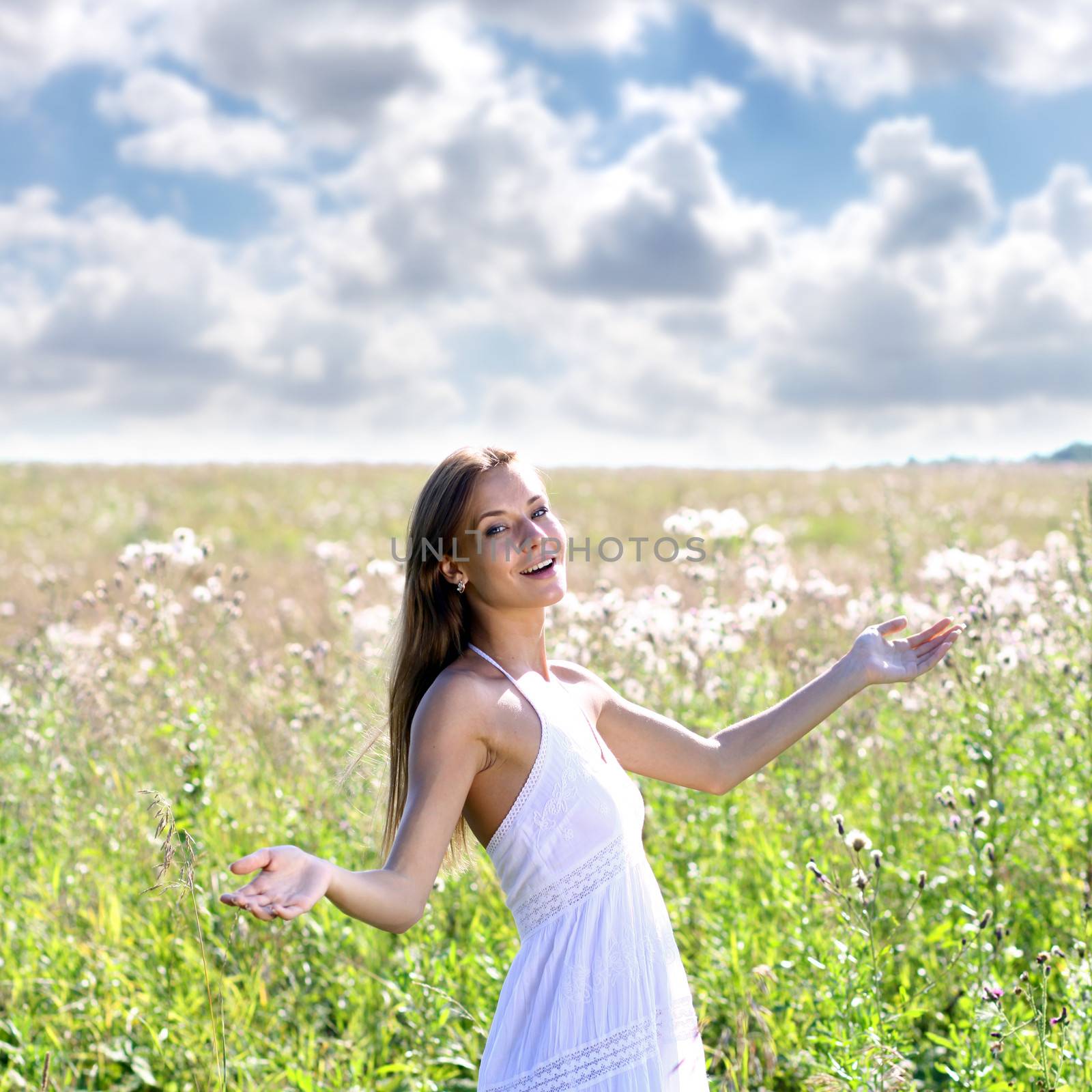 Young woman walks in summer field by andersonrise