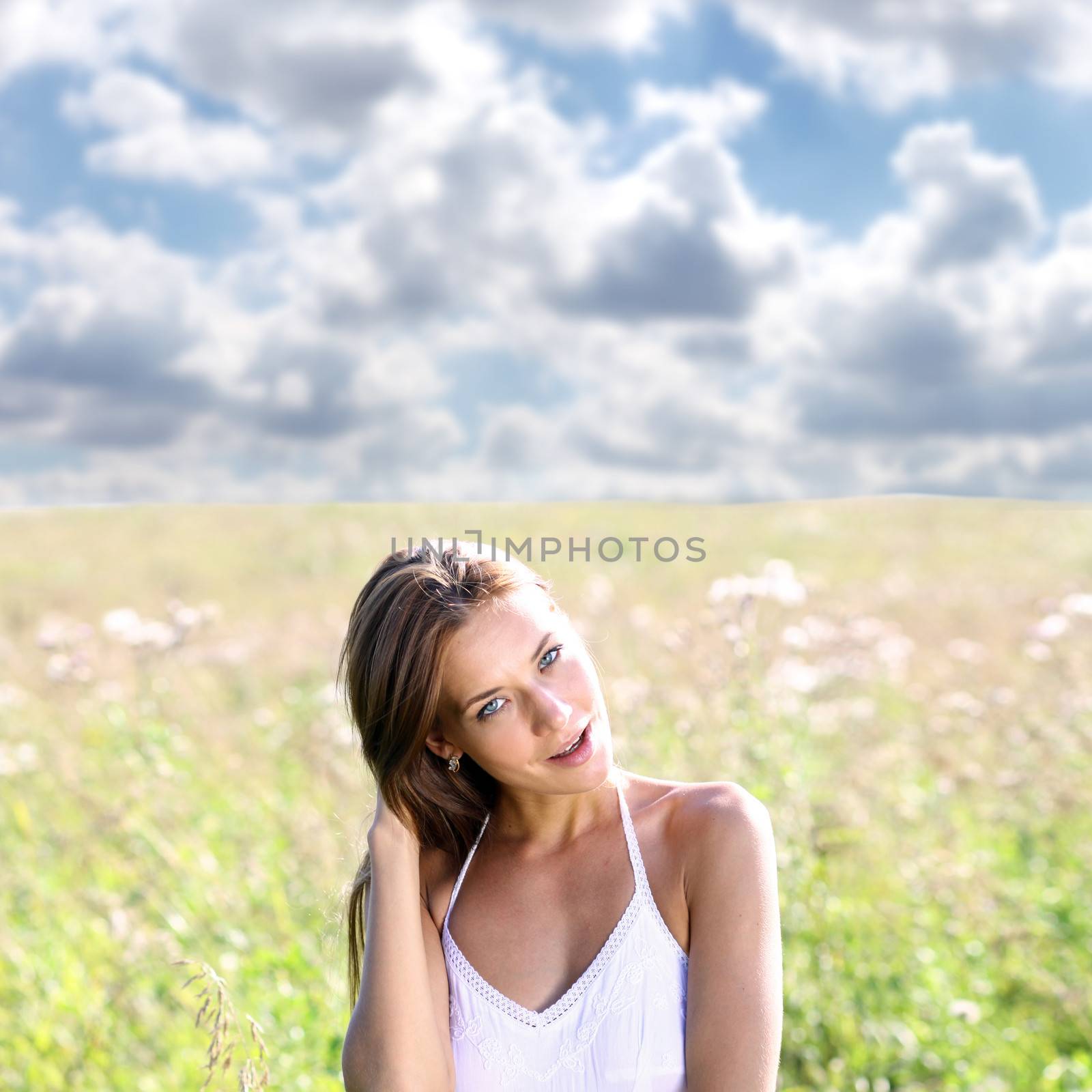 Young woman walks in summer field by andersonrise