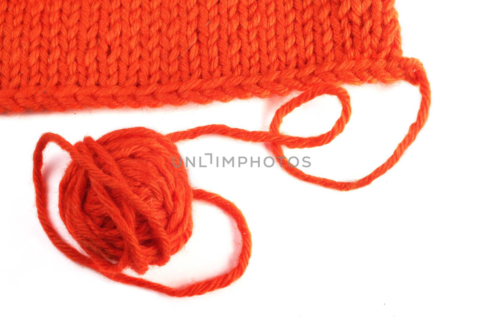 Wool yarn and knitted textile isolated on white background