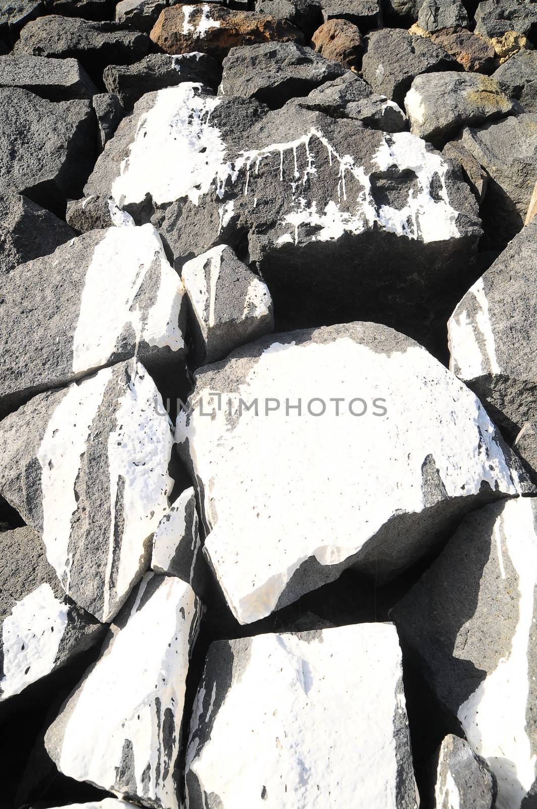 Texture Gray Rock Ancient Wall made of Volcanic Rocks and Dropping Paint