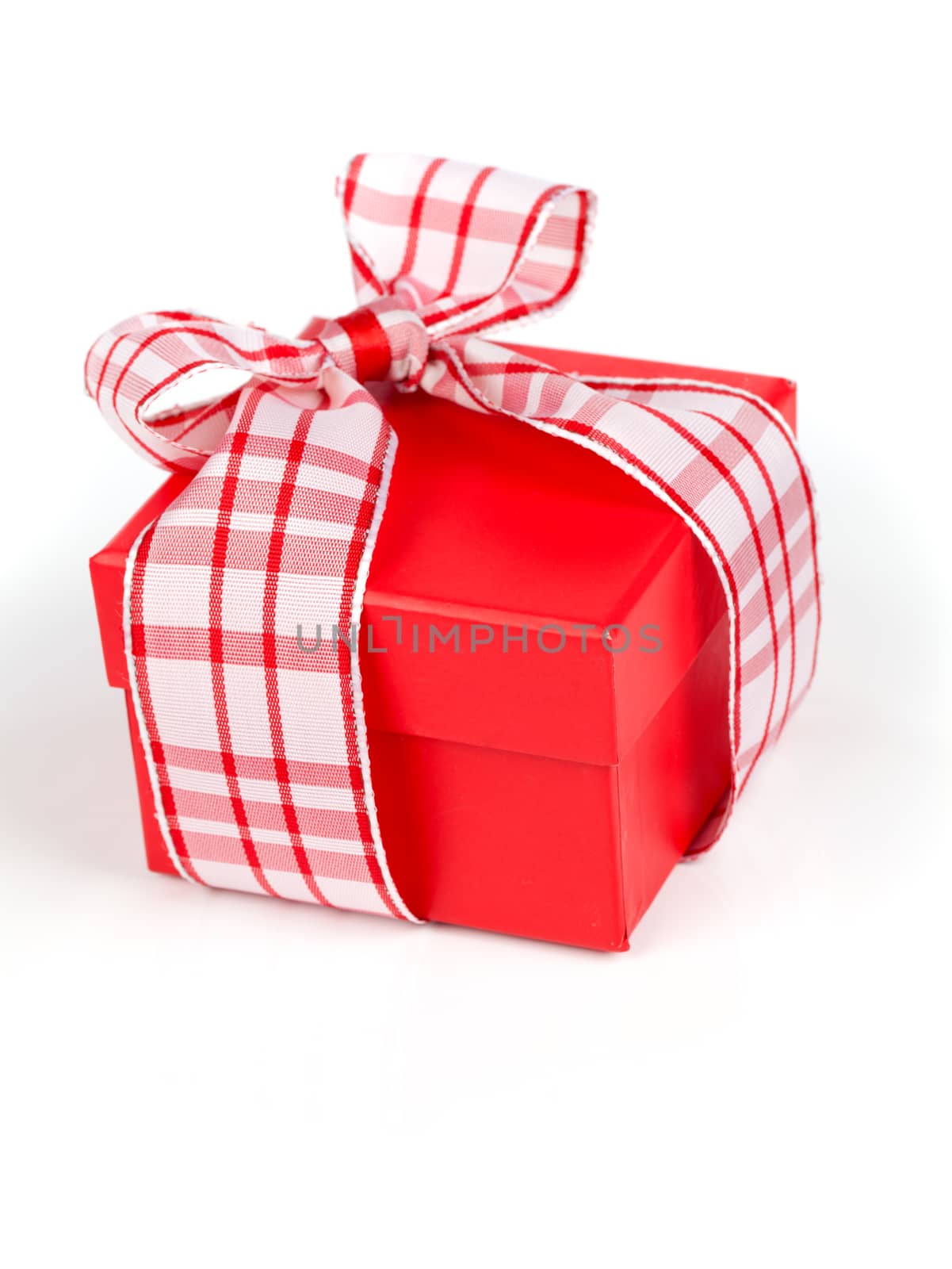 Single red gift box with ribbon, on white background.