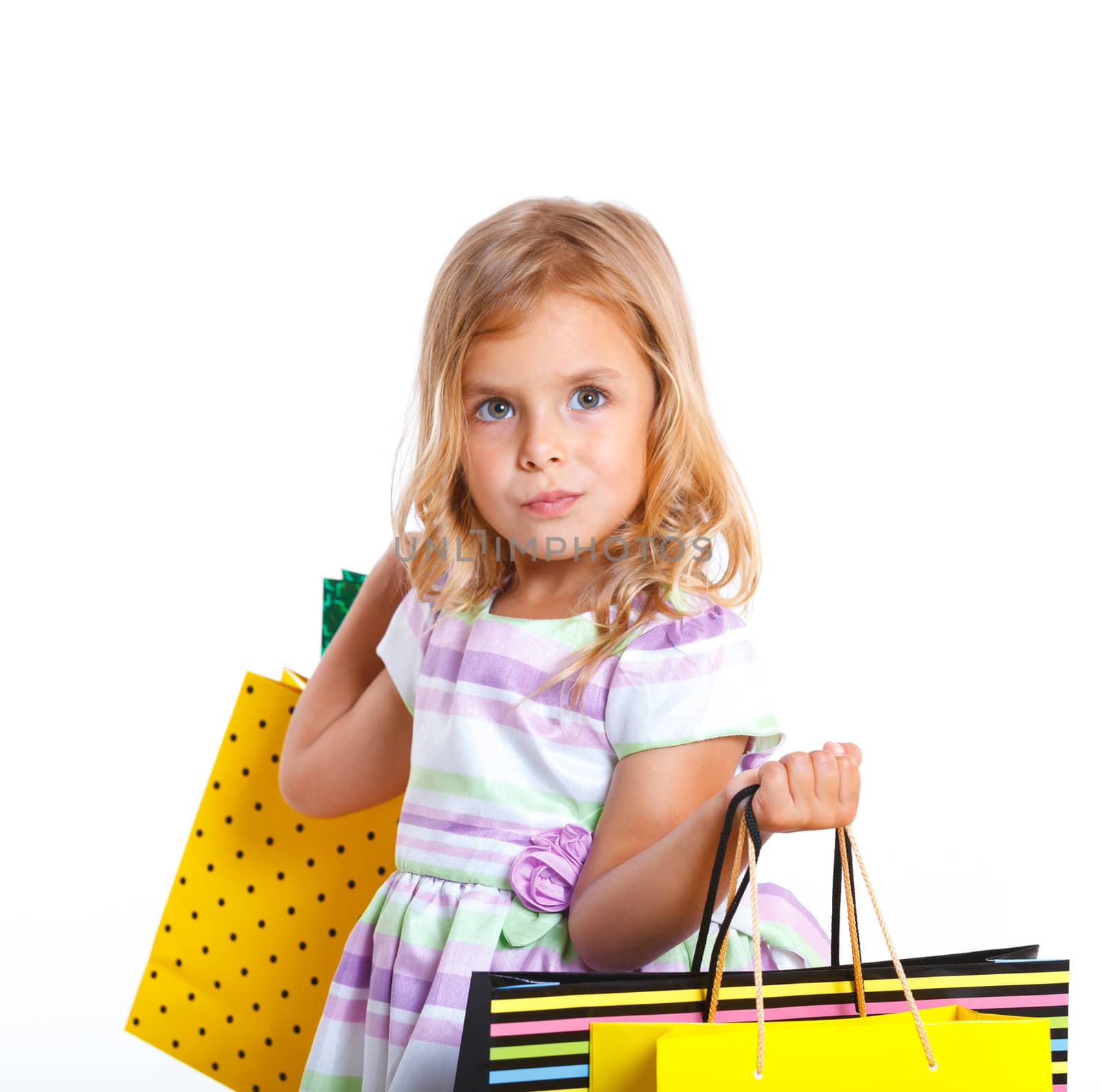 Shopping little girl happy smiling holding shopping bags isolated on white background.