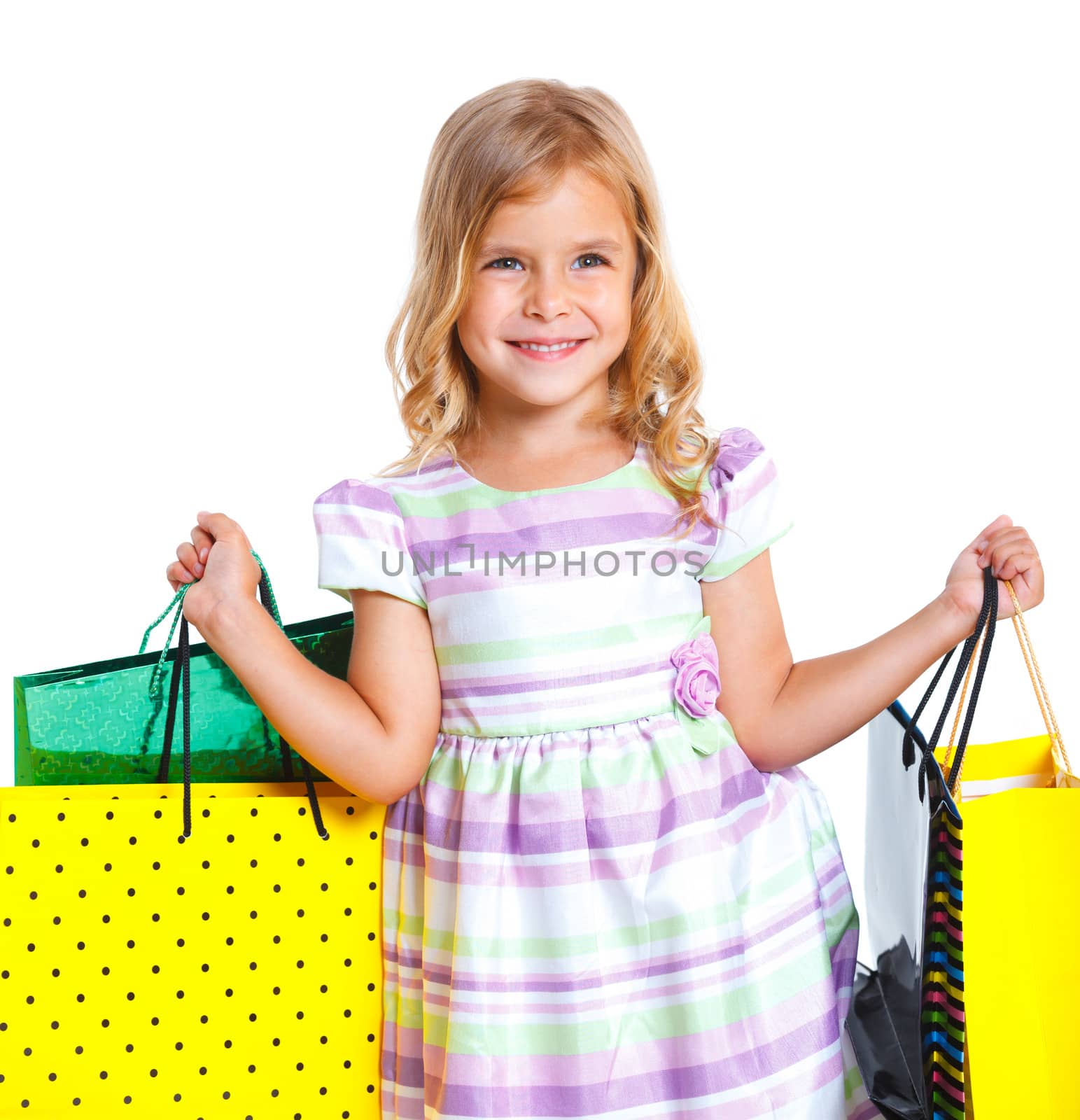 Shopping little girl happy smiling holding shopping bags isolated on white background.