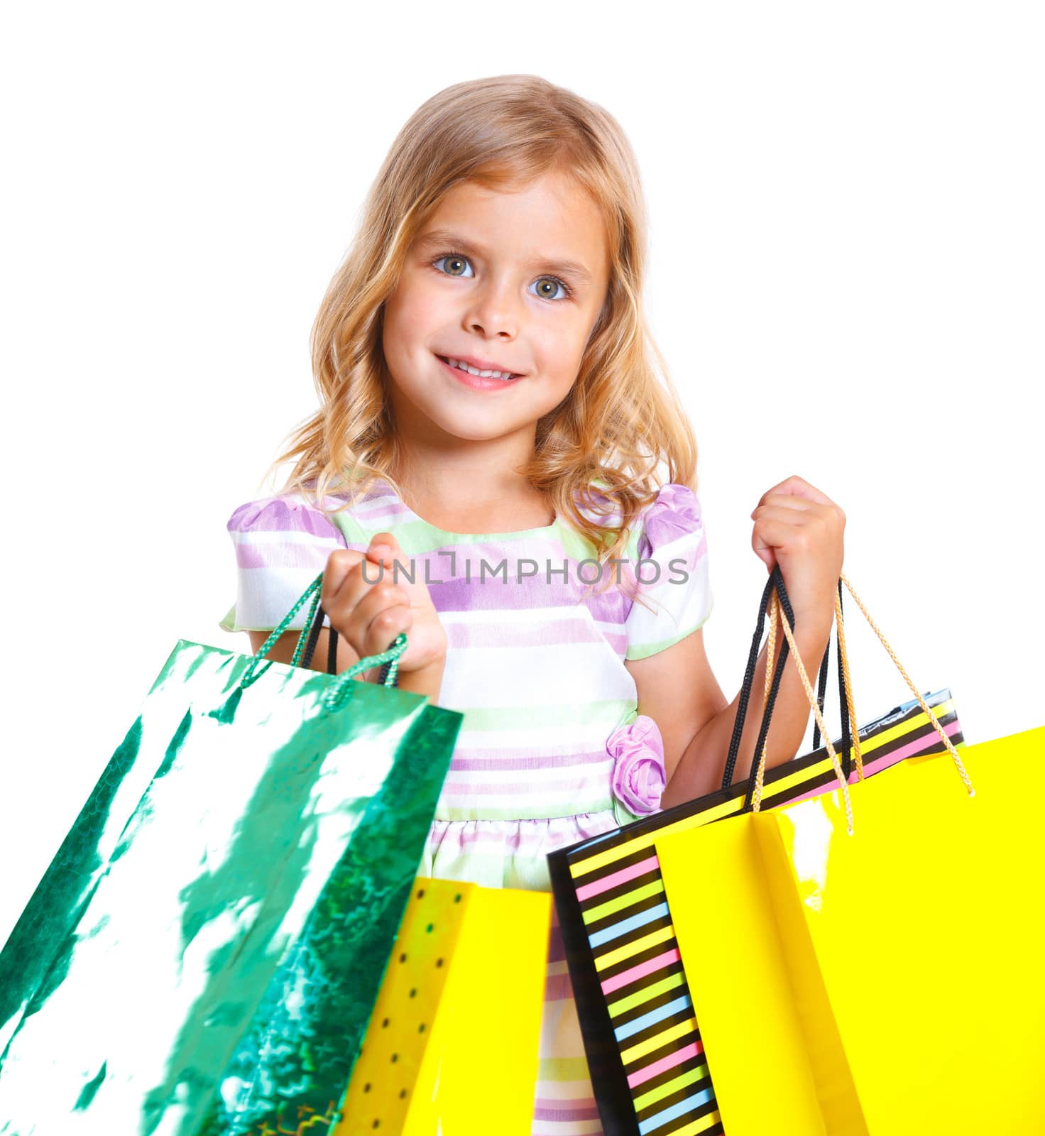 Shopping little girl happy smiling holding shopping bags isolated on white background.