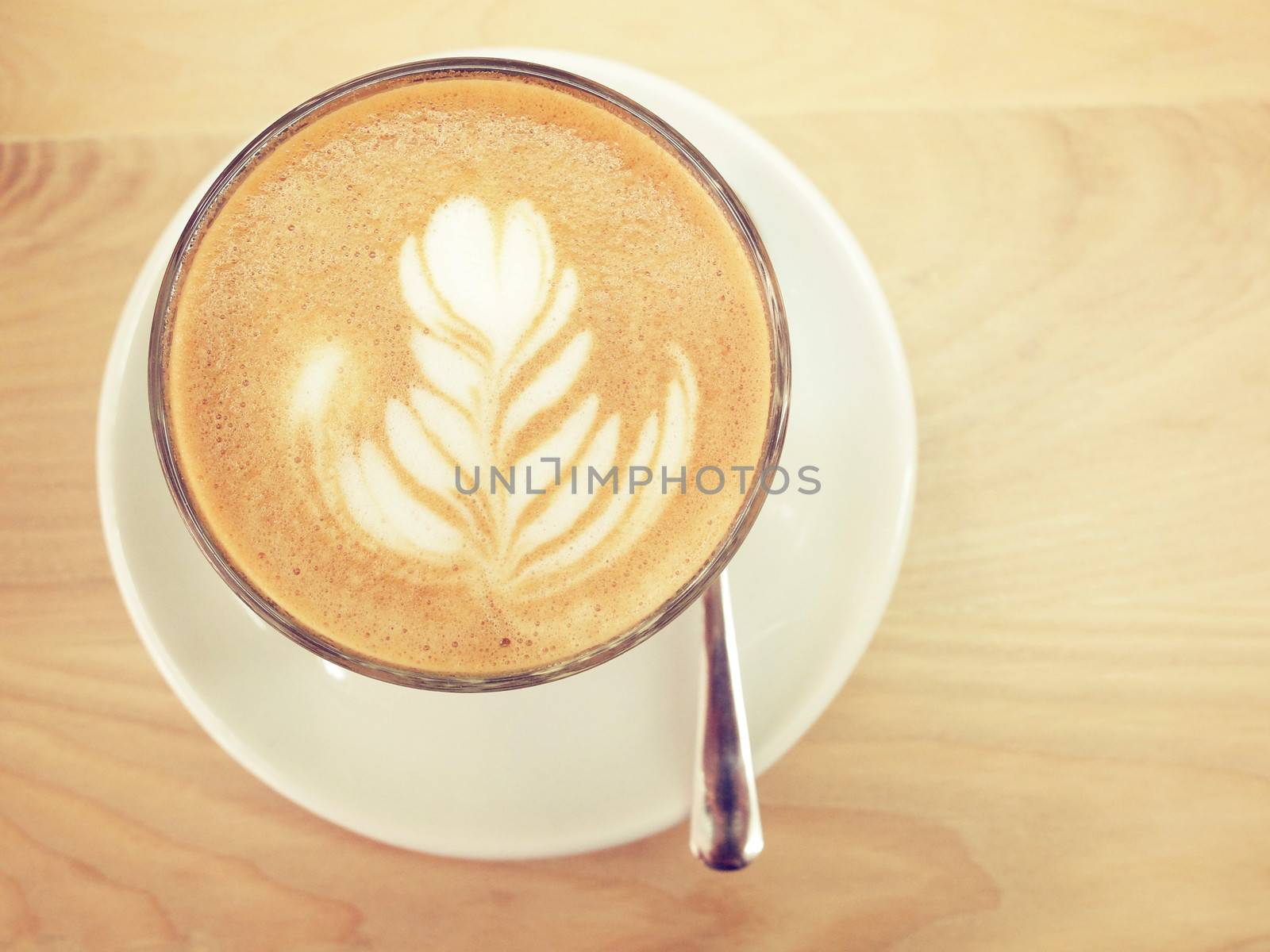 Cappuccino or latte coffee on table with retro filter effect by nuchylee