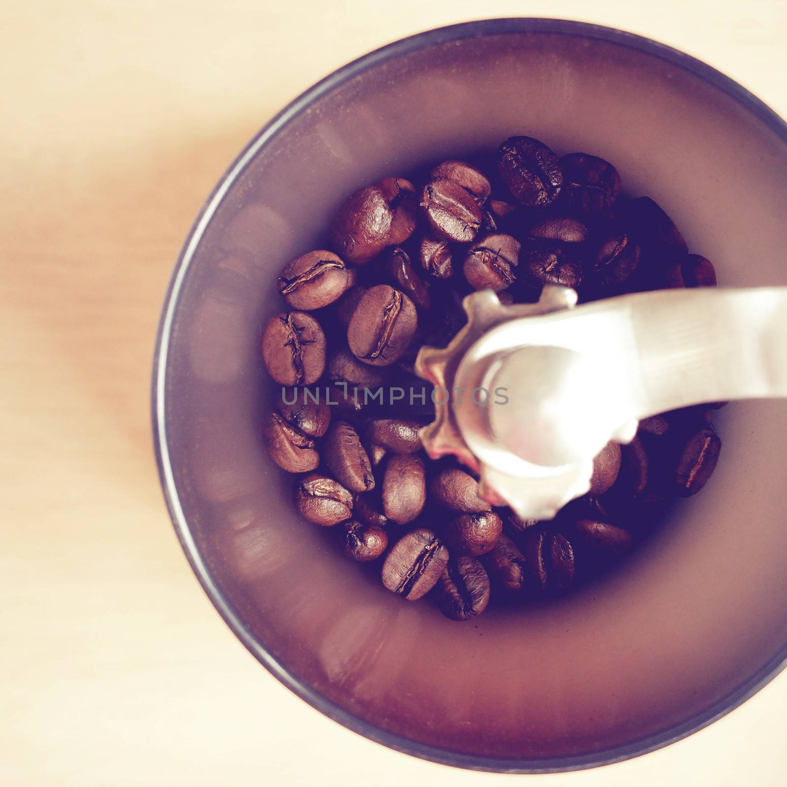 Manual coffee grinder with coffee beans by nuchylee