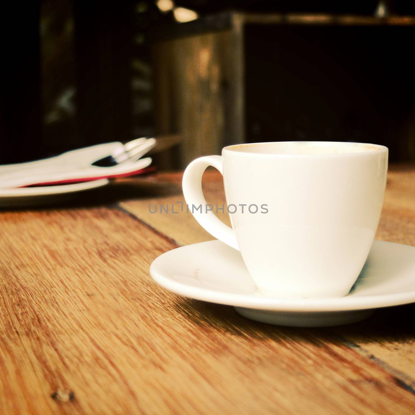 Closeup of cup of coffee on table at coffee shop by nuchylee