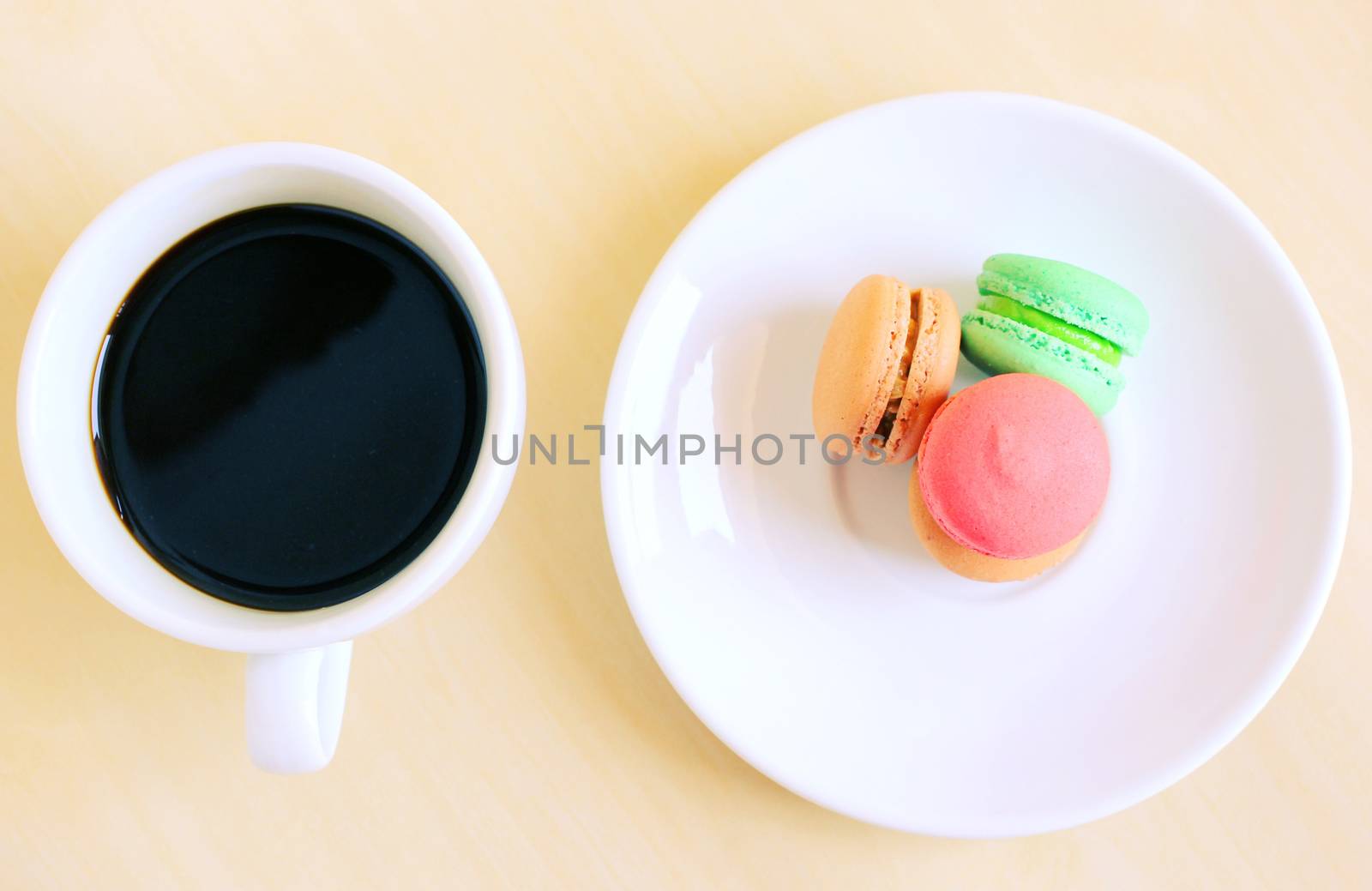 Colorful macaroons and cup of coffee with retro filter effect by nuchylee