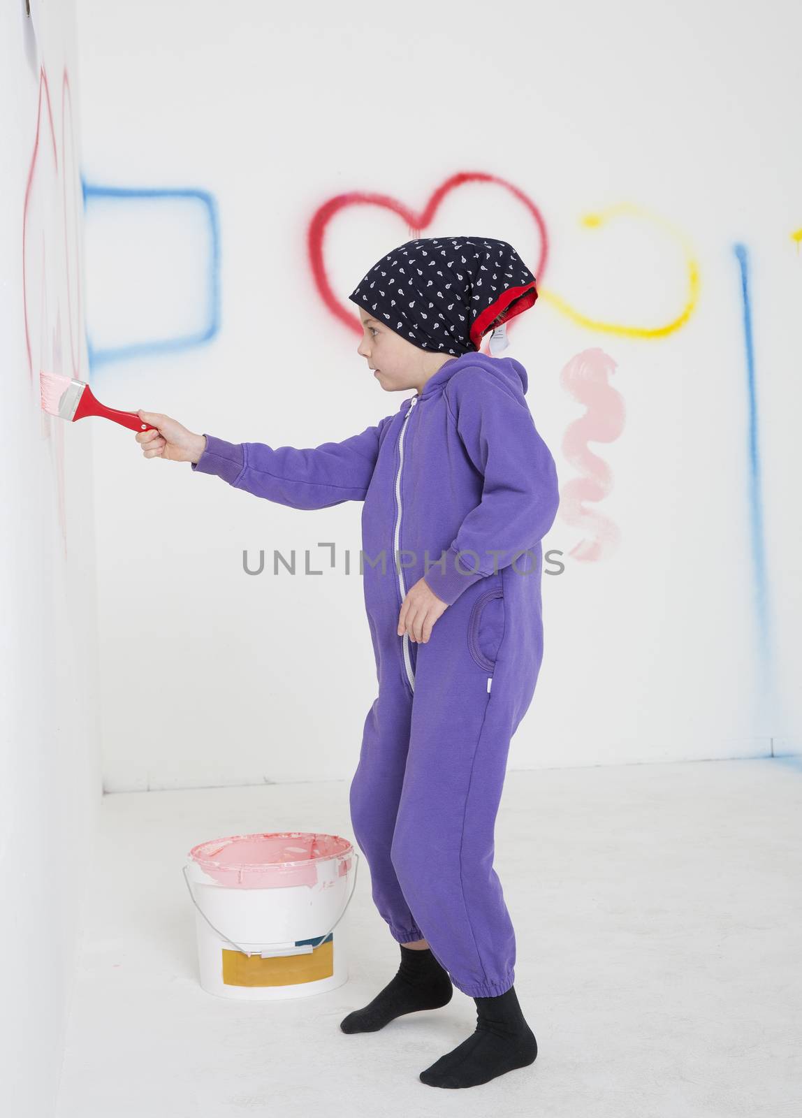 Young Girl painting in a white room