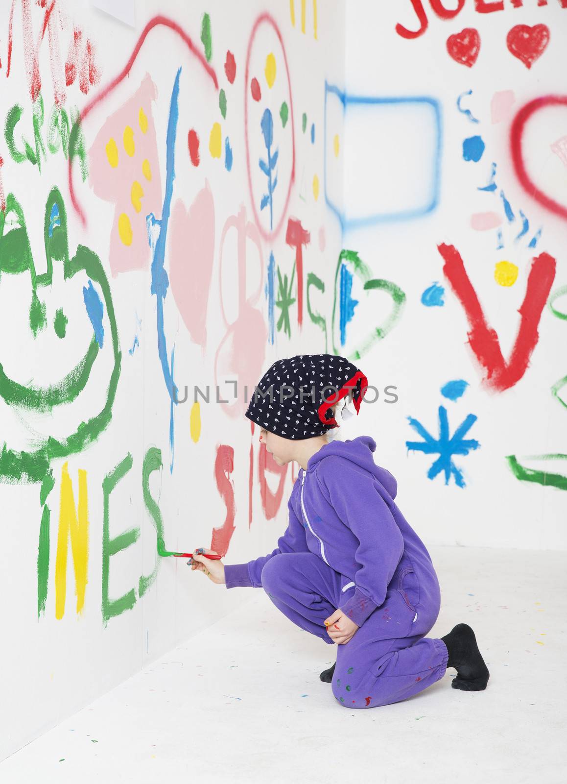 Young Girl Painting in a white room