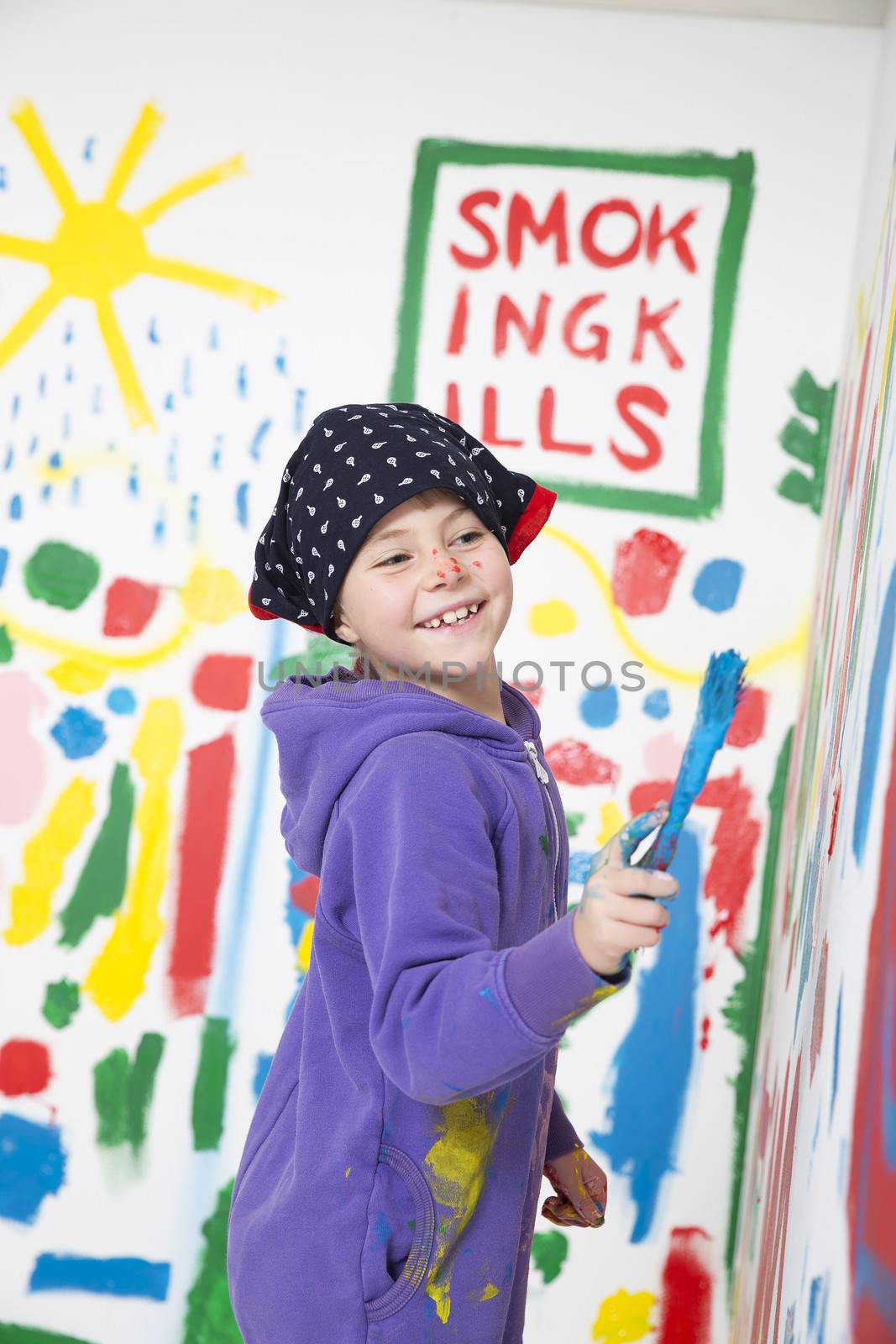 Young Artist painting with a smile on her face