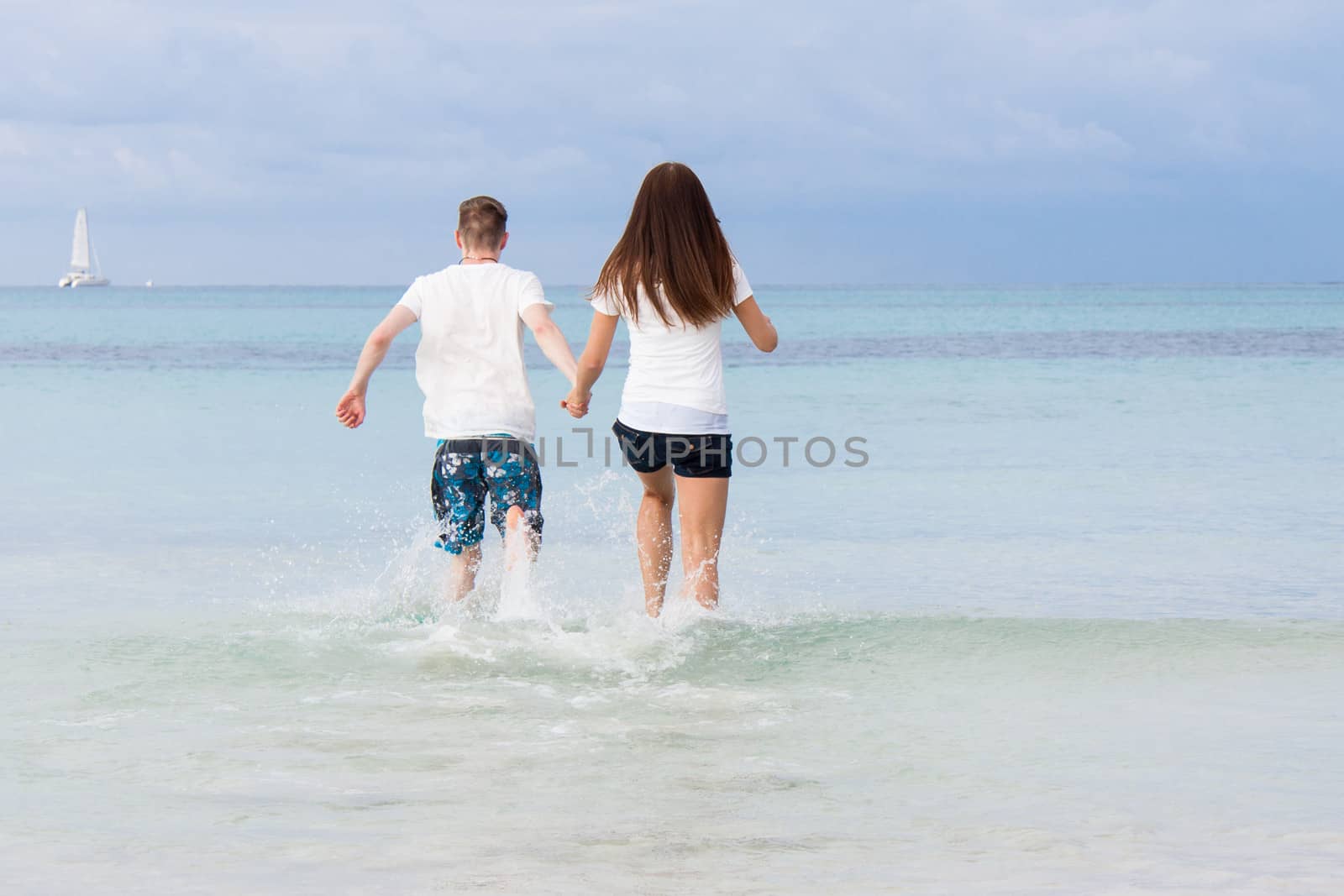 young happy couple in summer holiday vacation summertime beach