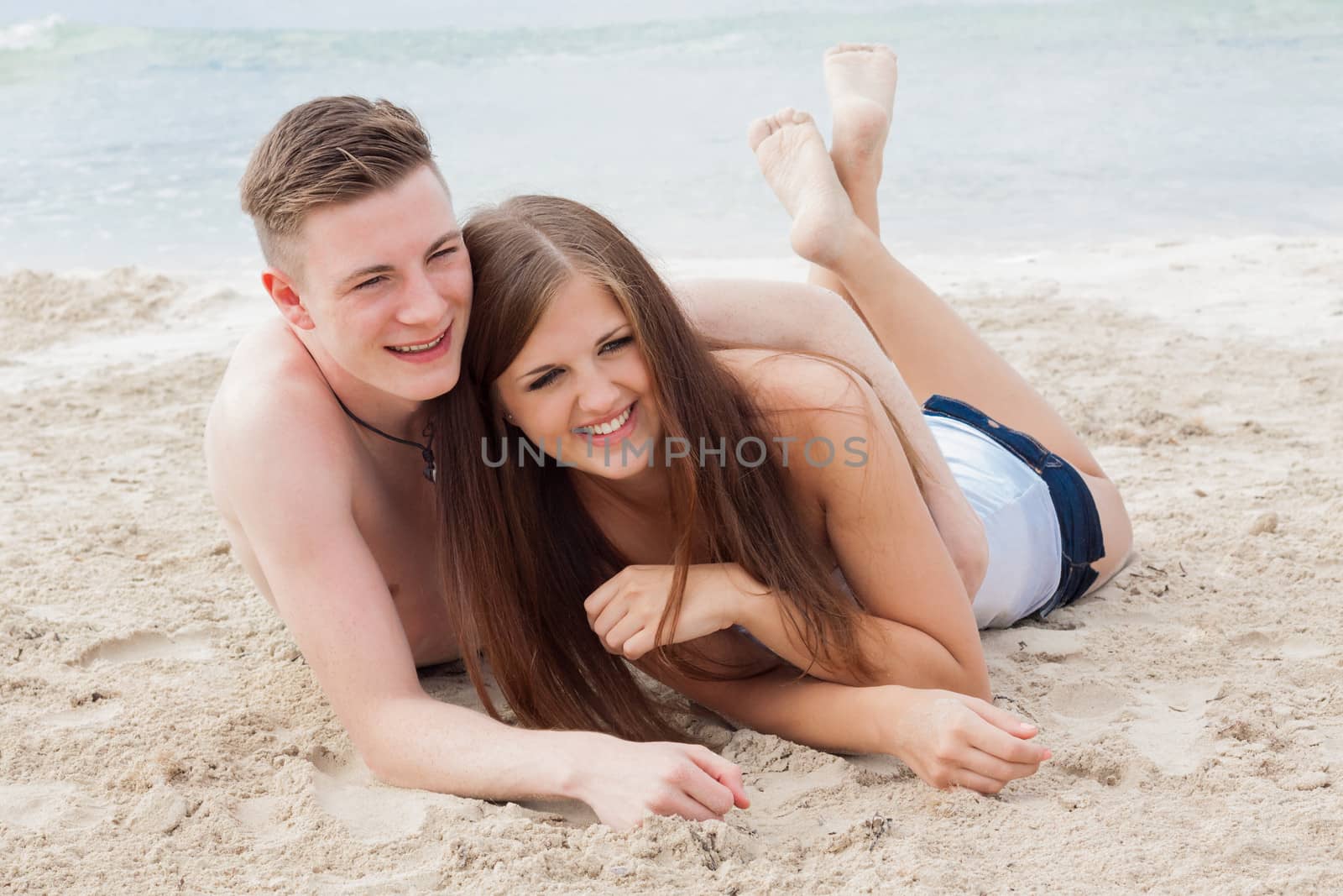 young happy couple in summer holiday vacation summertime beach