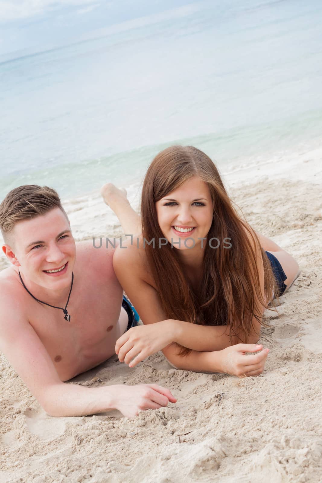 young happy couple in summer holiday vacation summertime beach