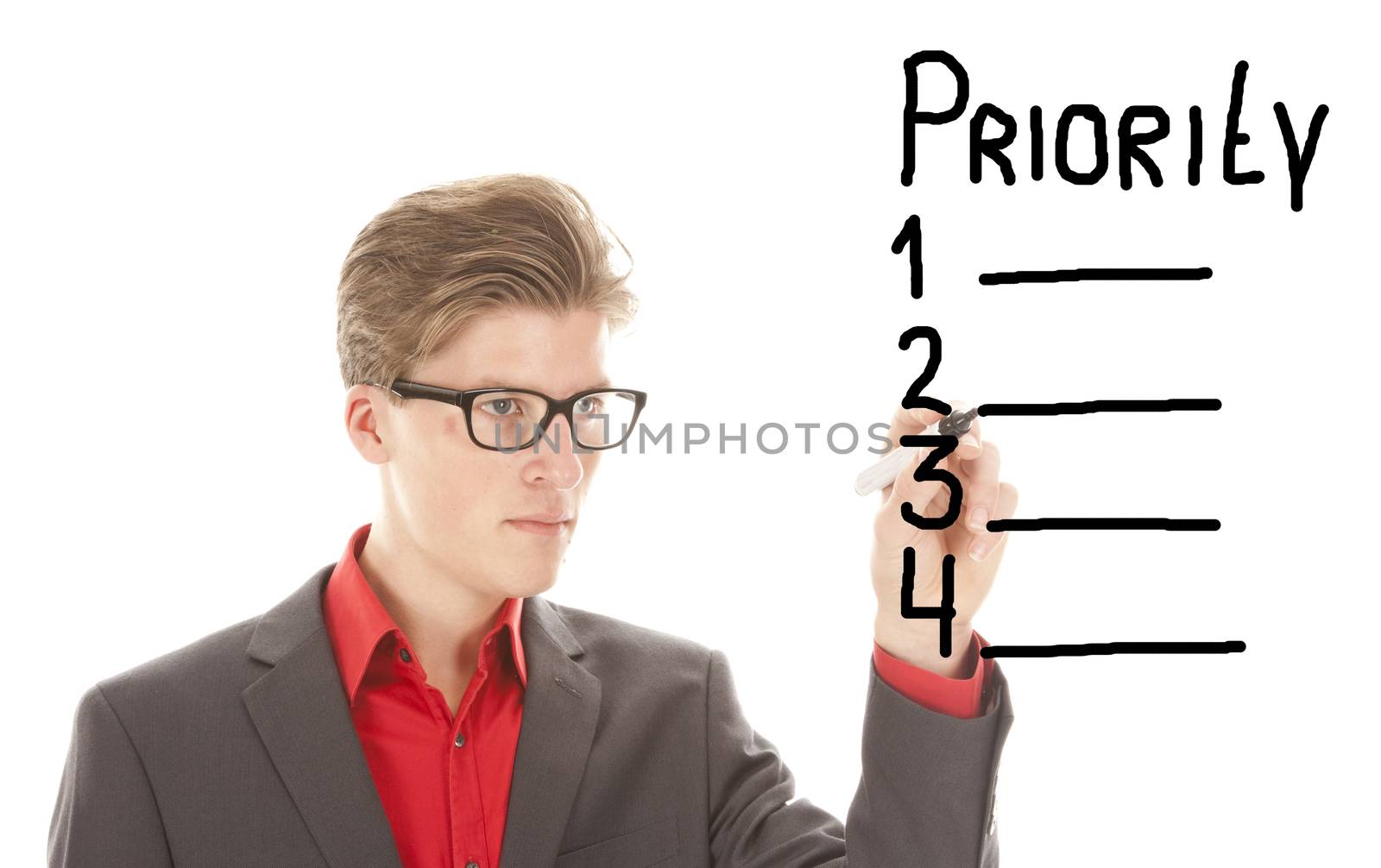 Young man writing priority items isolated on white background
