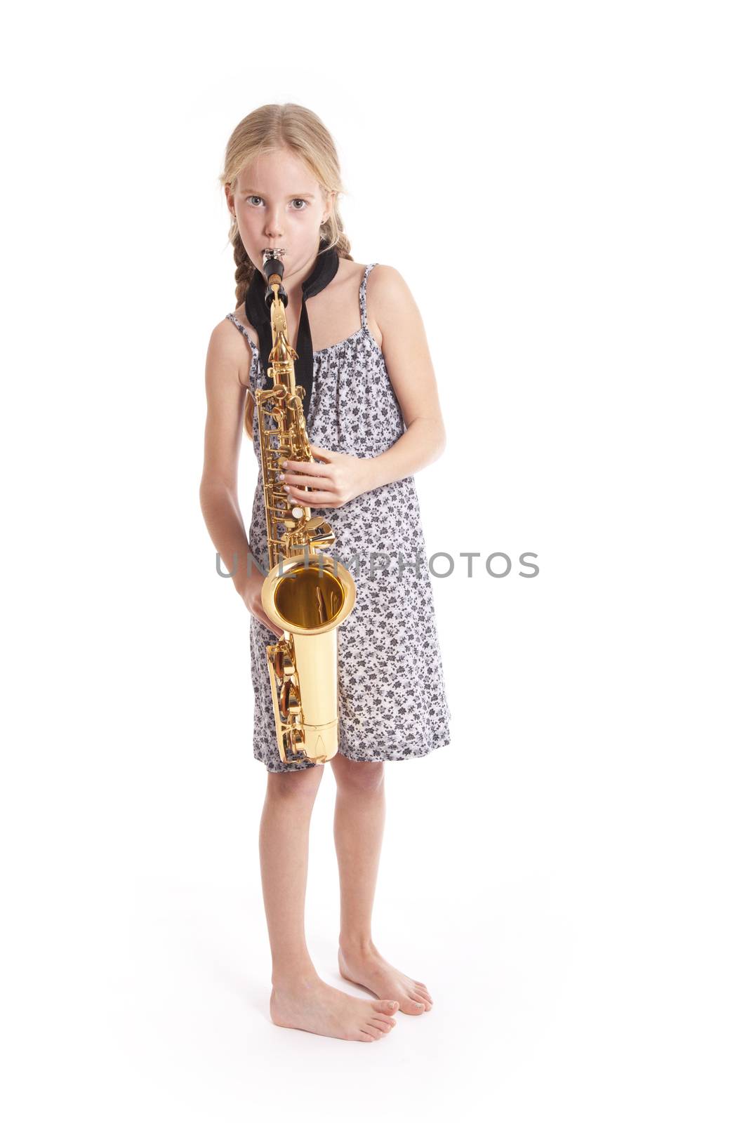 young girl in dress playing saxophone standing by ahavelaar