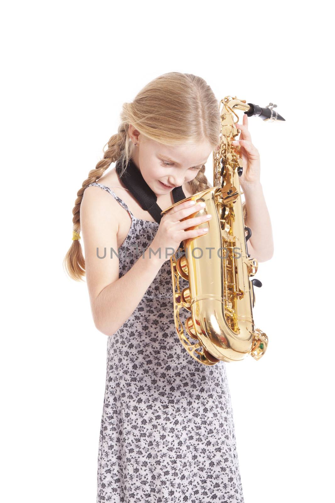 young girl in dress looking into saxophone by ahavelaar