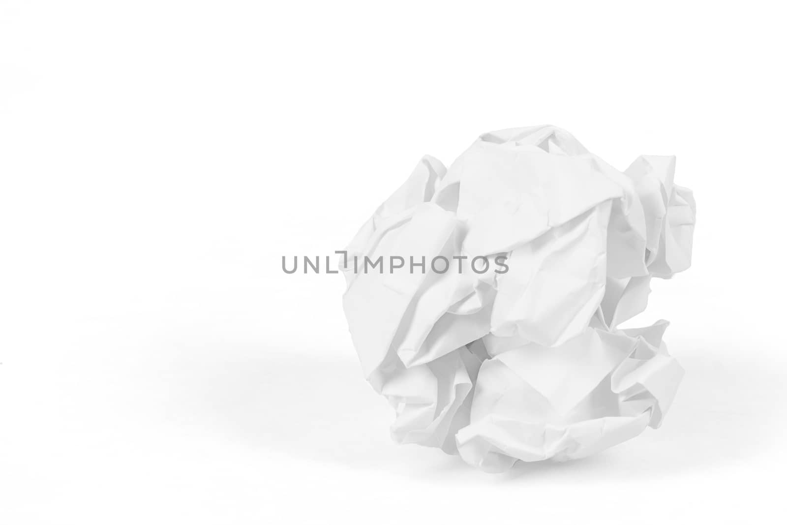 close-up of crumpled paper ball on white background