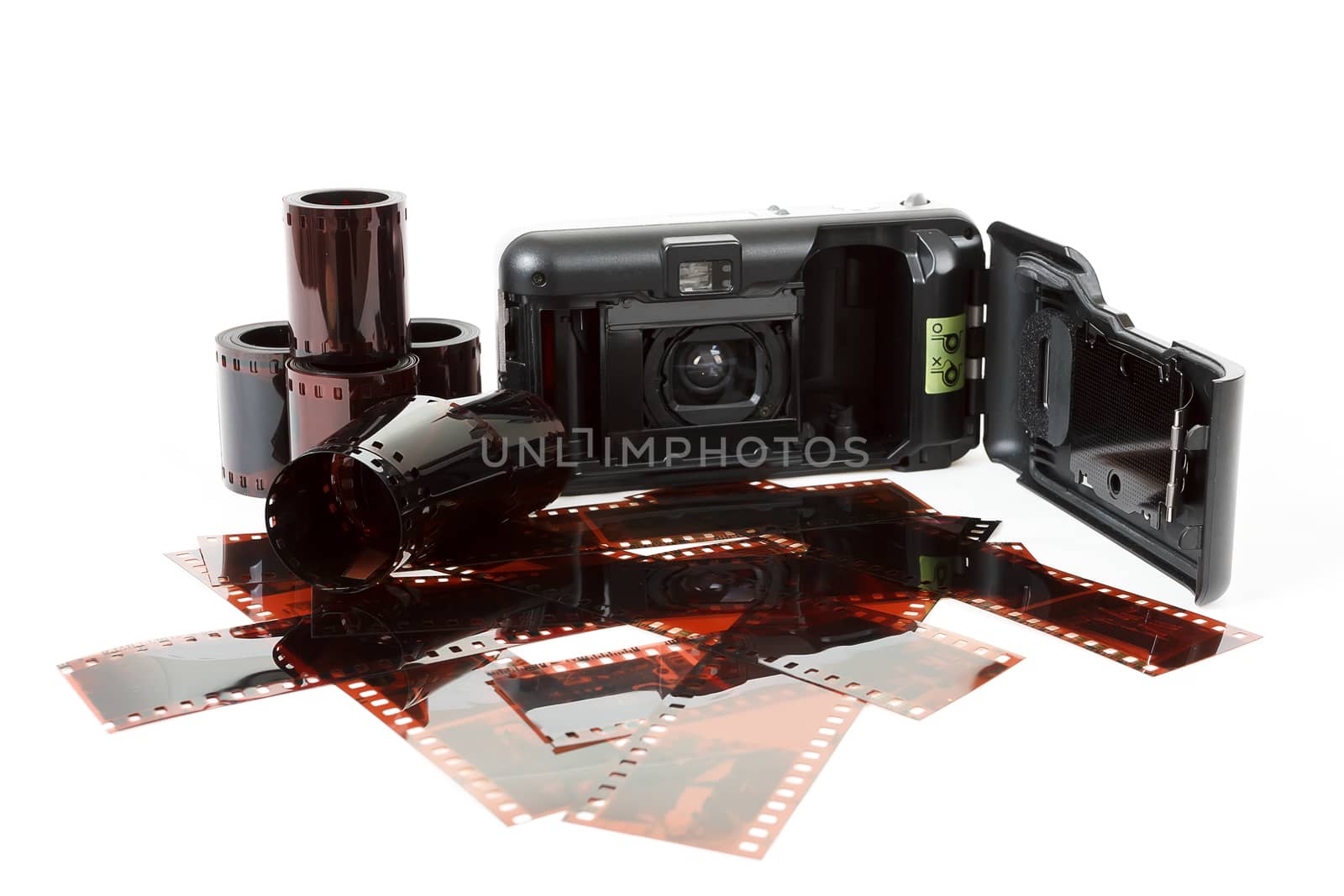 analog photo camera and color negative films on white