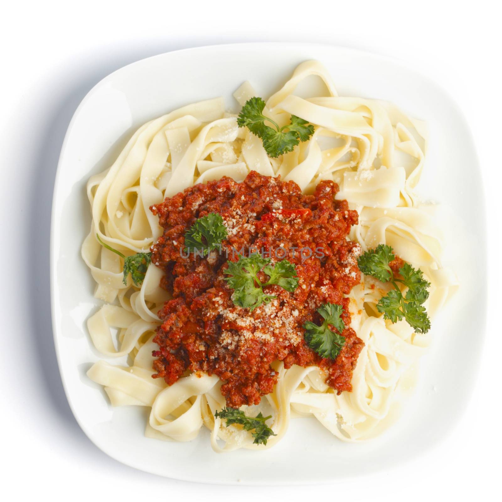 Spaghetti bolognese on white plate top view