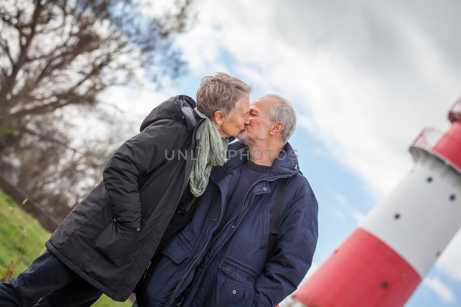 happy mature couple relaxing baltic sea dunes in autumn