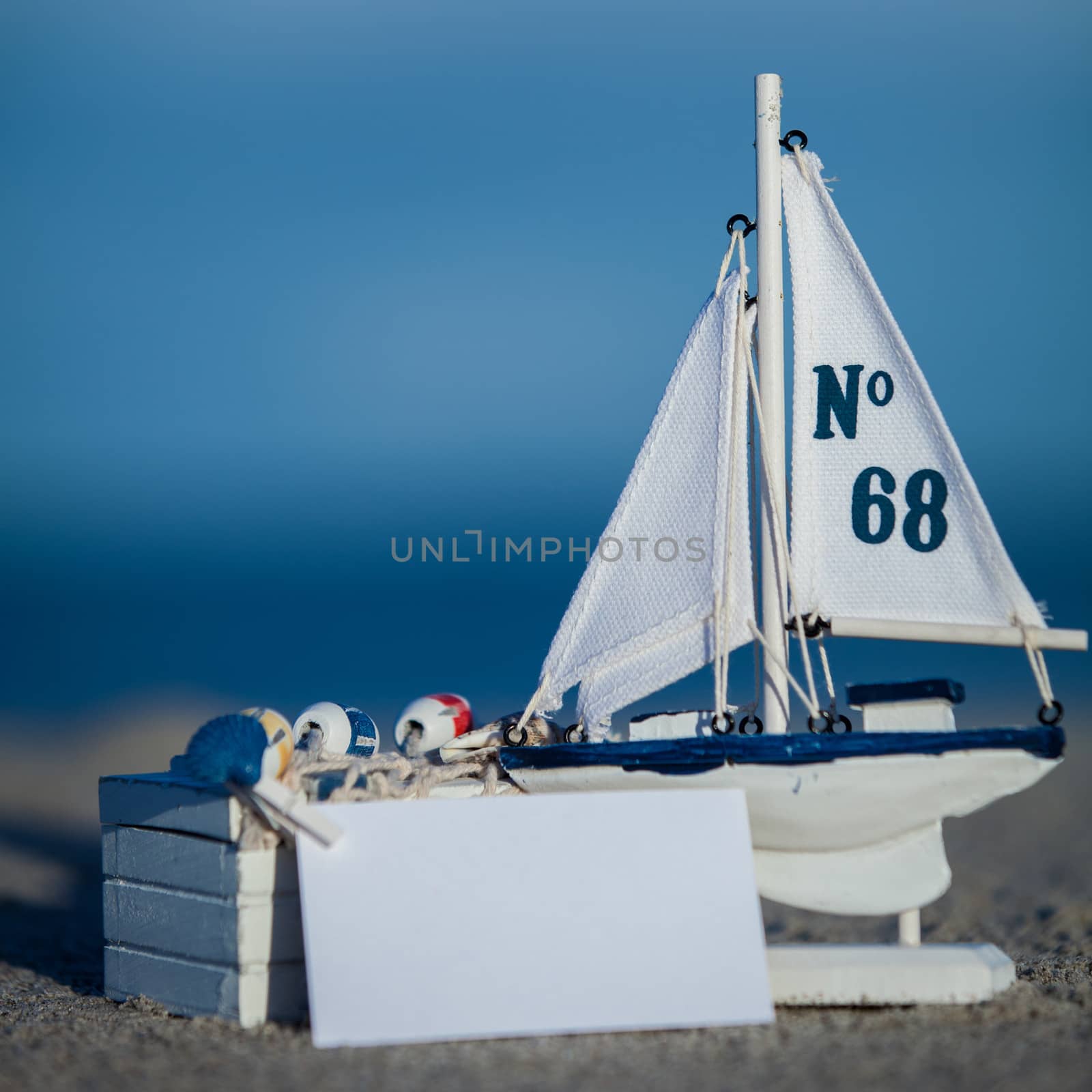 sailing boat and seashell in sand decoration closeup holiday background