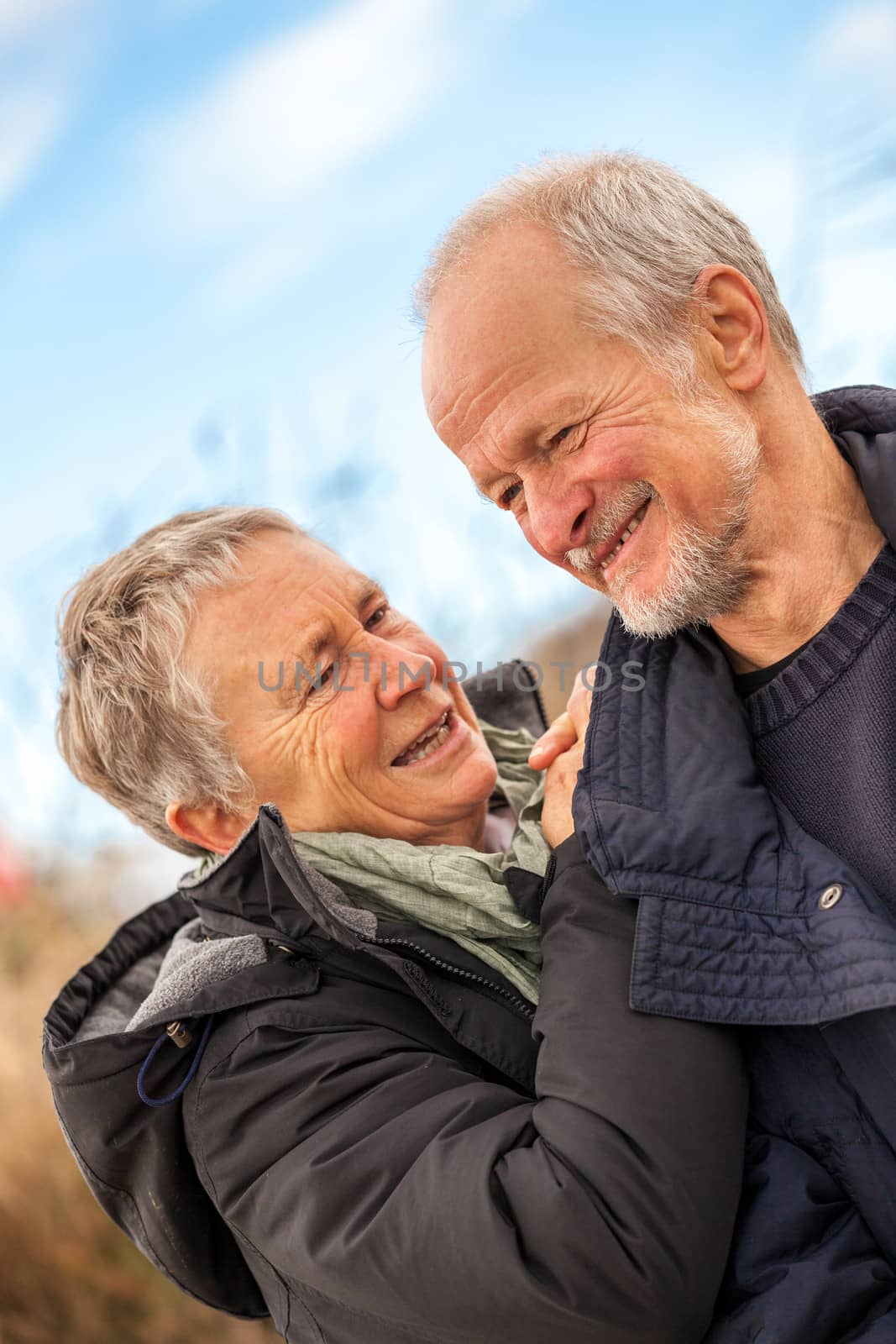 happy mature couple relaxing baltic sea dunes in autumn