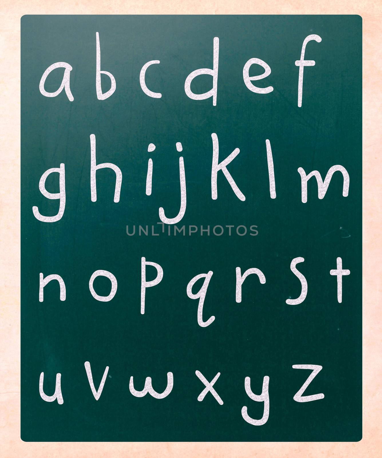 Complete english alphabet handwritten with white chalk on a blackboard