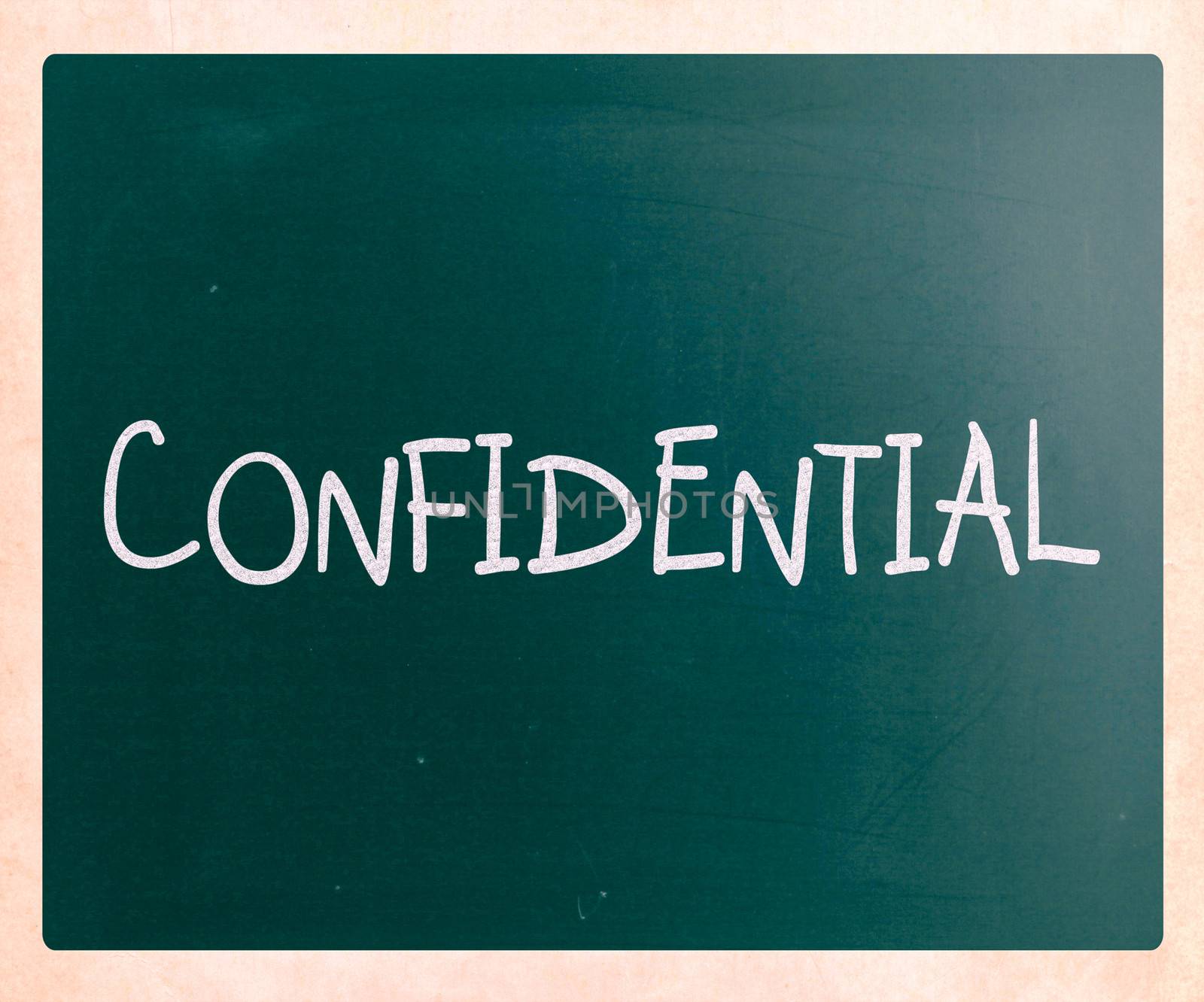 The word "Confidential" handwritten with white chalk on a blackboard
