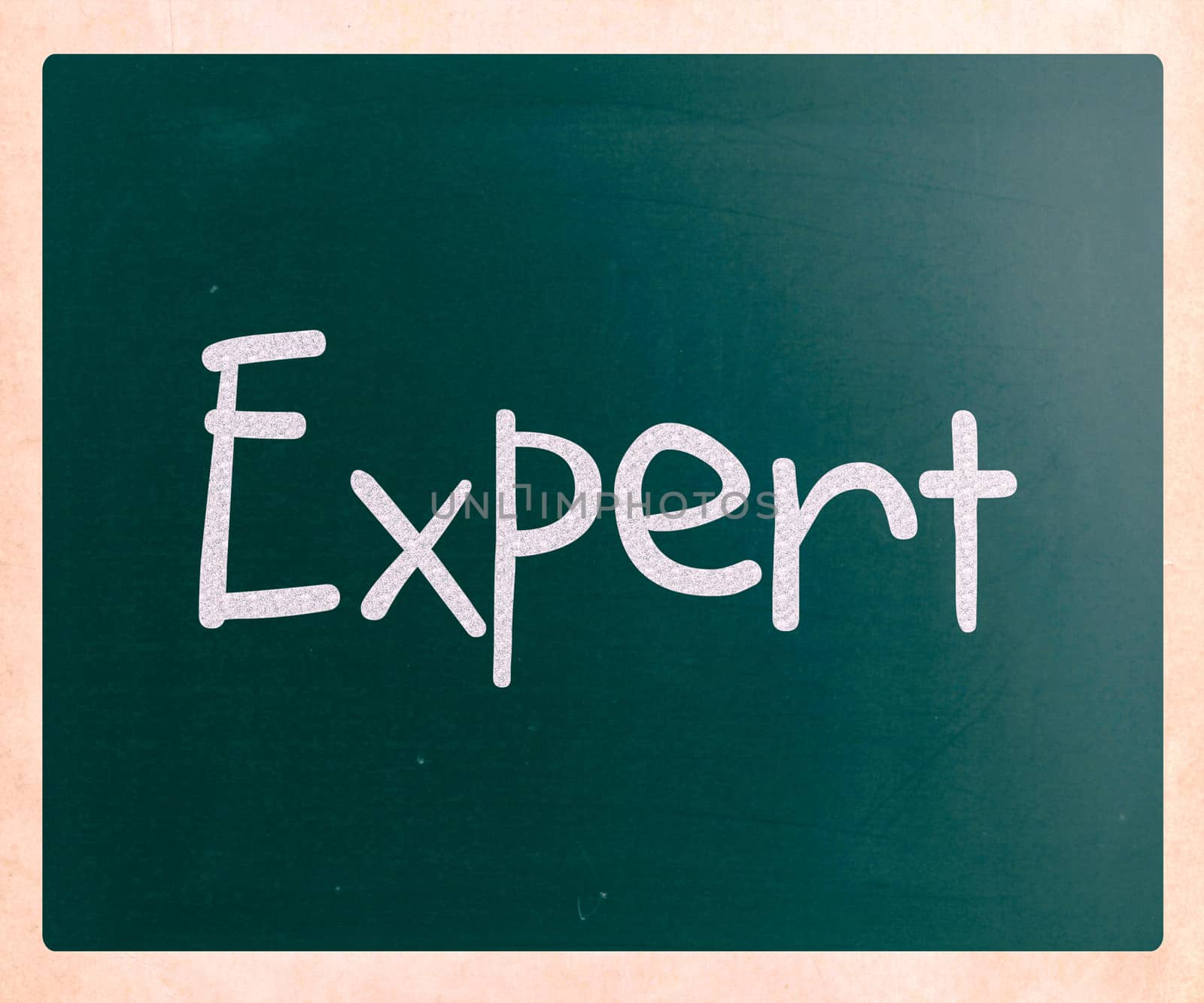 The word "Expert" handwritten with white chalk on a blackboard