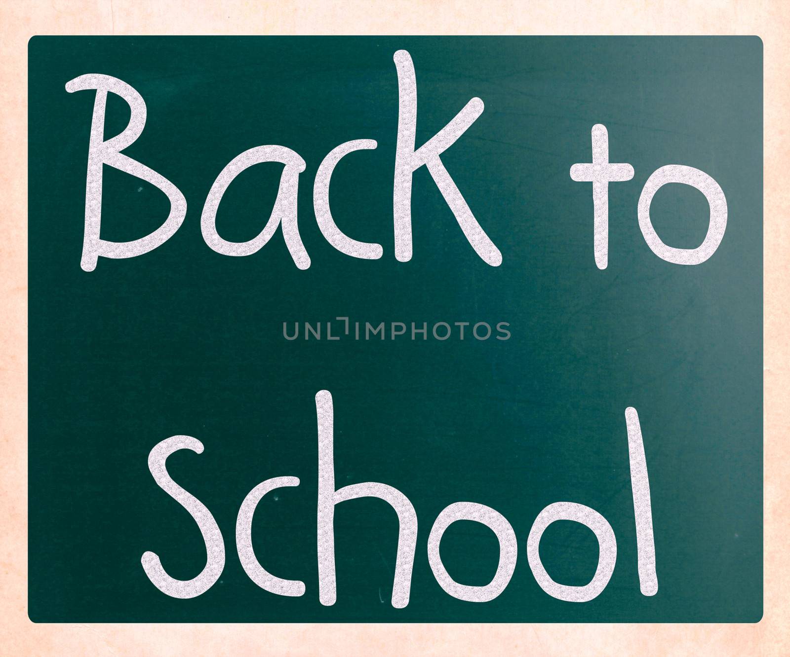 "Back to school" handwritten with white chalk on a blackboard