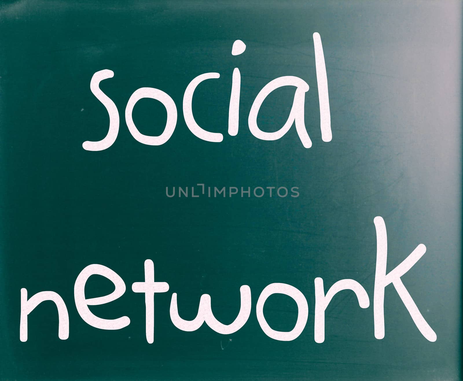 The word "Social network" handwritten with white chalk on a blackboard