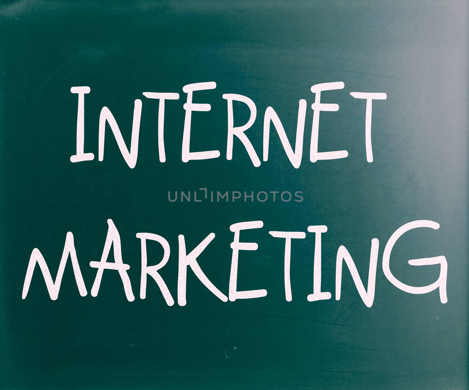 "Internet marketing" handwritten with white chalk on a blackboard