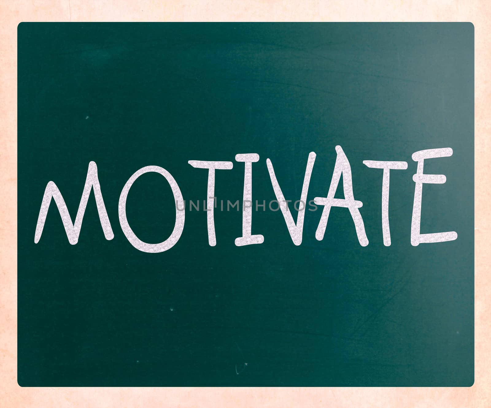 "Motivate" handwritten with white chalk on a blackboard