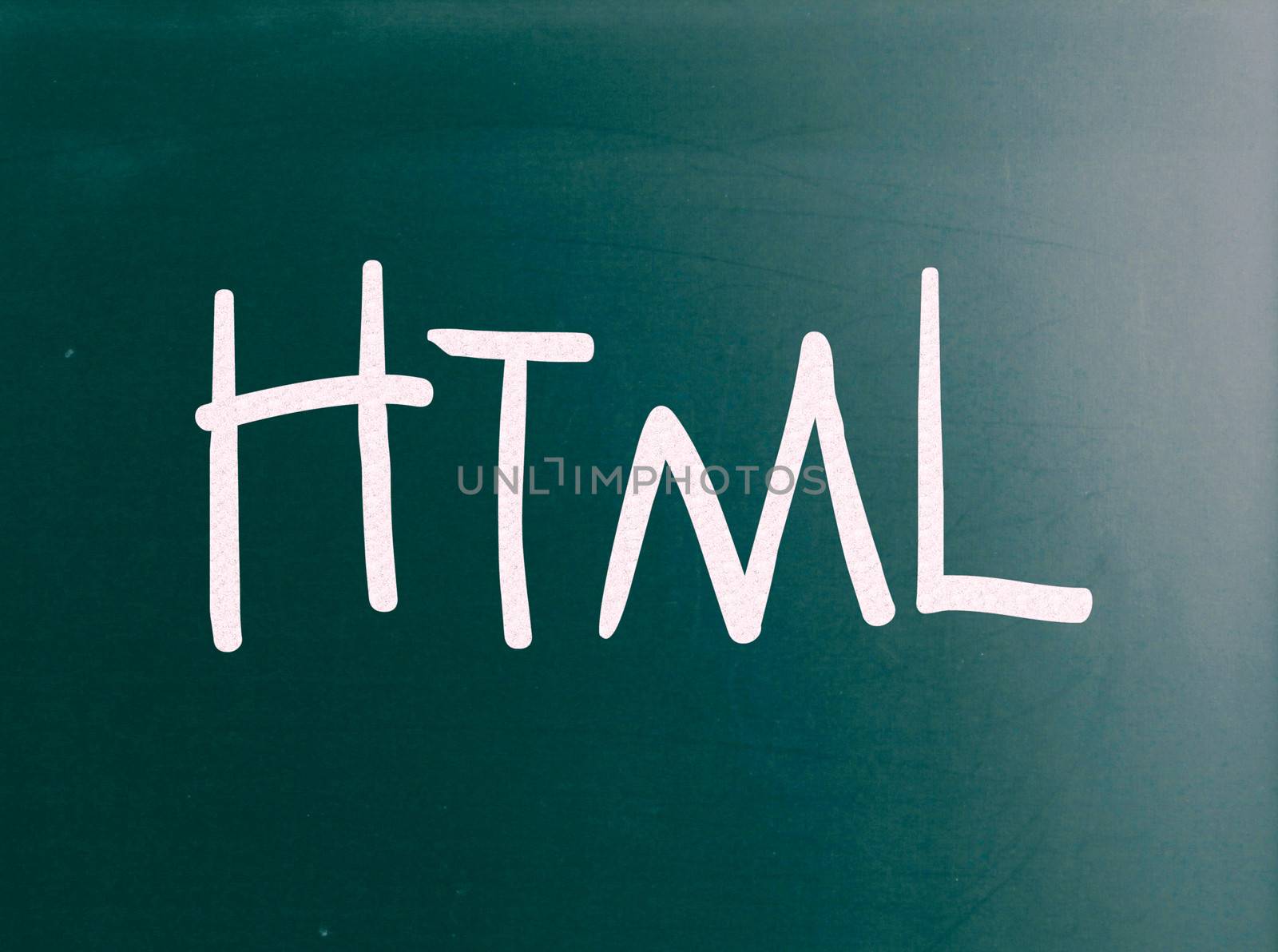 The word "HTML" handwritten with white chalk on a blackboard