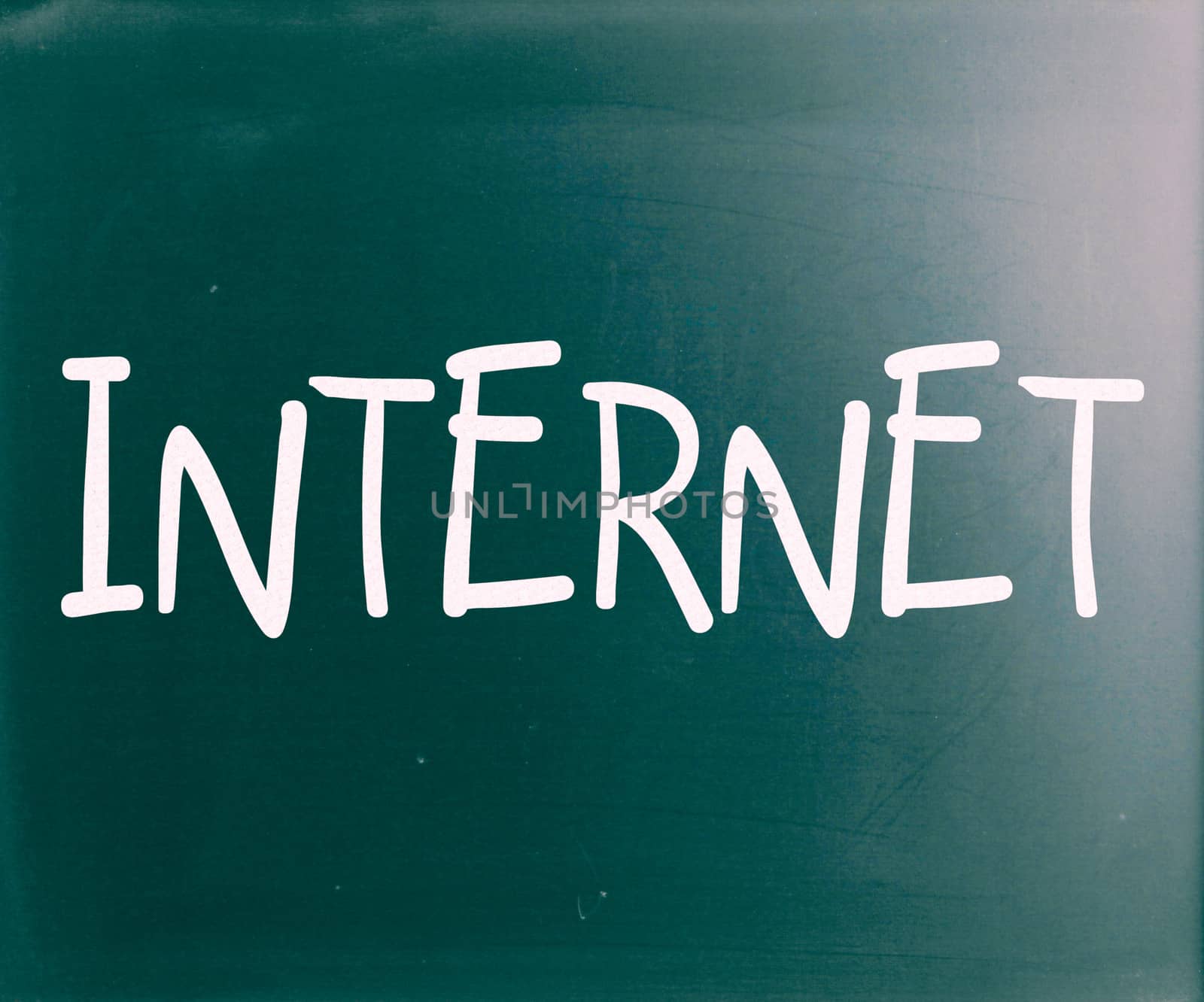 The word "Internet" handwritten with white chalk on a blackboard by nenov