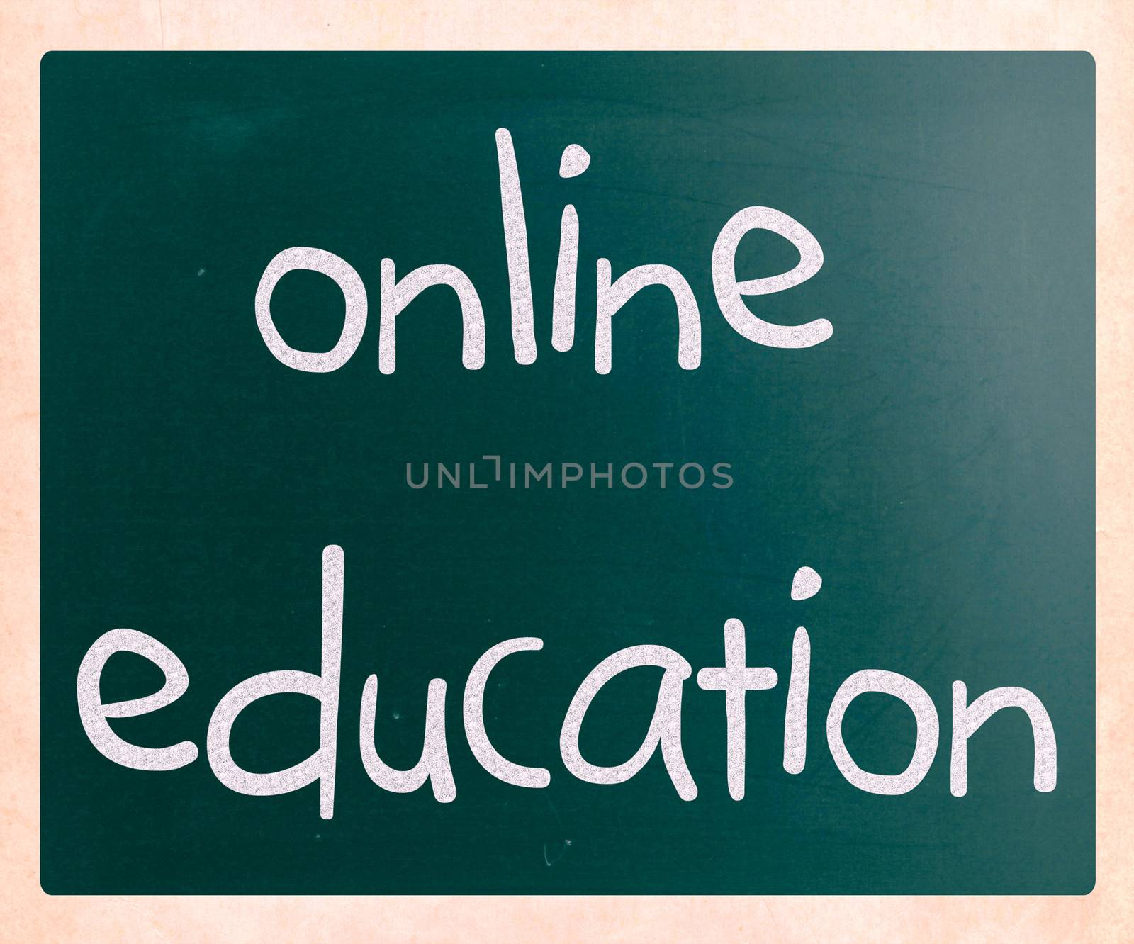 "Online education" handwritten with white chalk on a blackboard