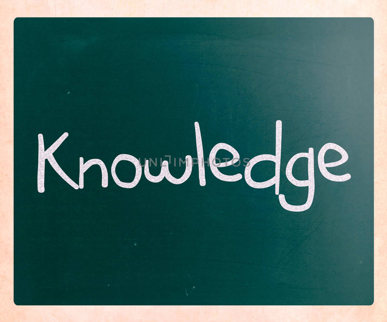 "Knowledge" handwritten with white chalk on a blackboard