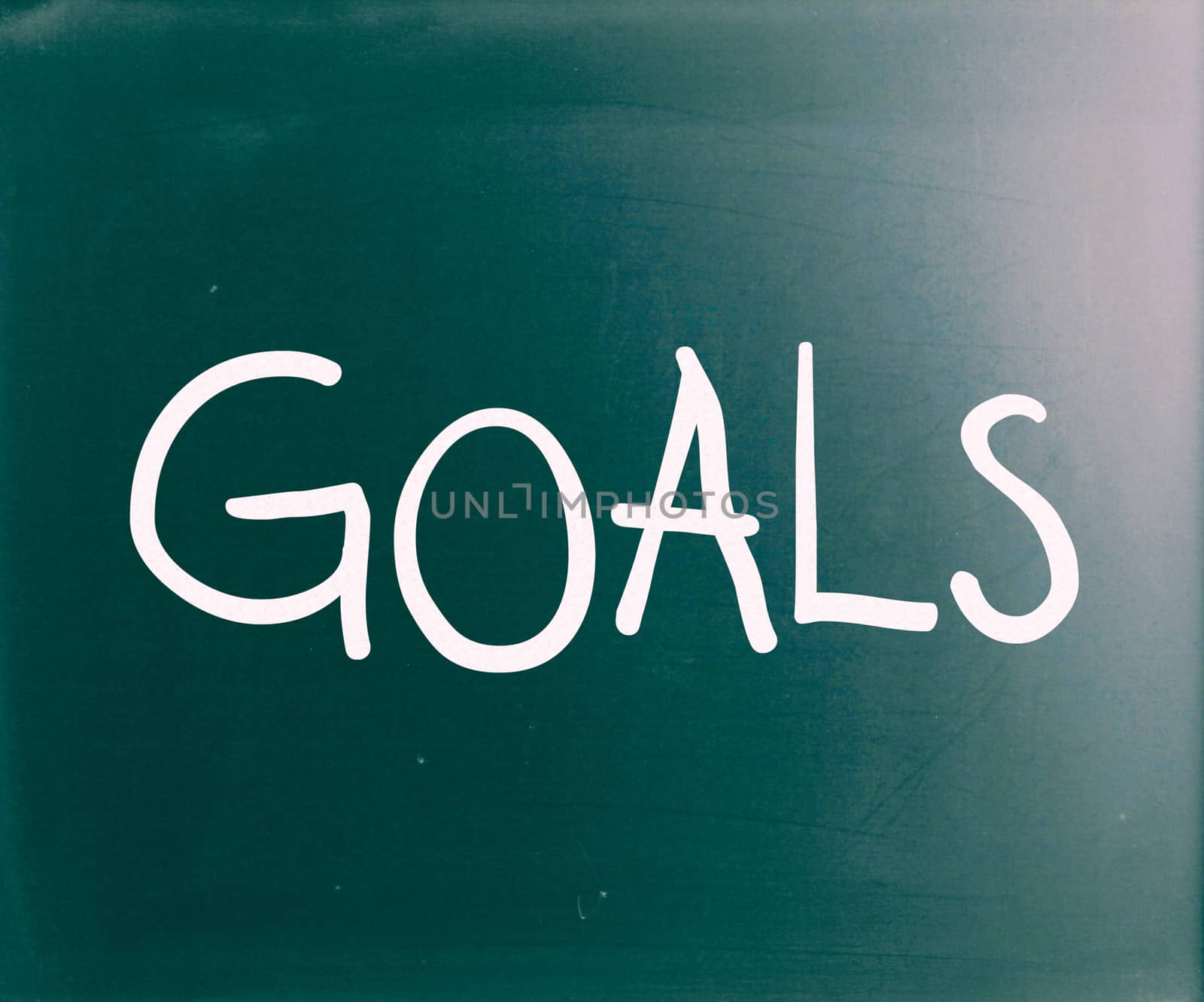 The word "Goals" handwritten with white chalk on a blackboard