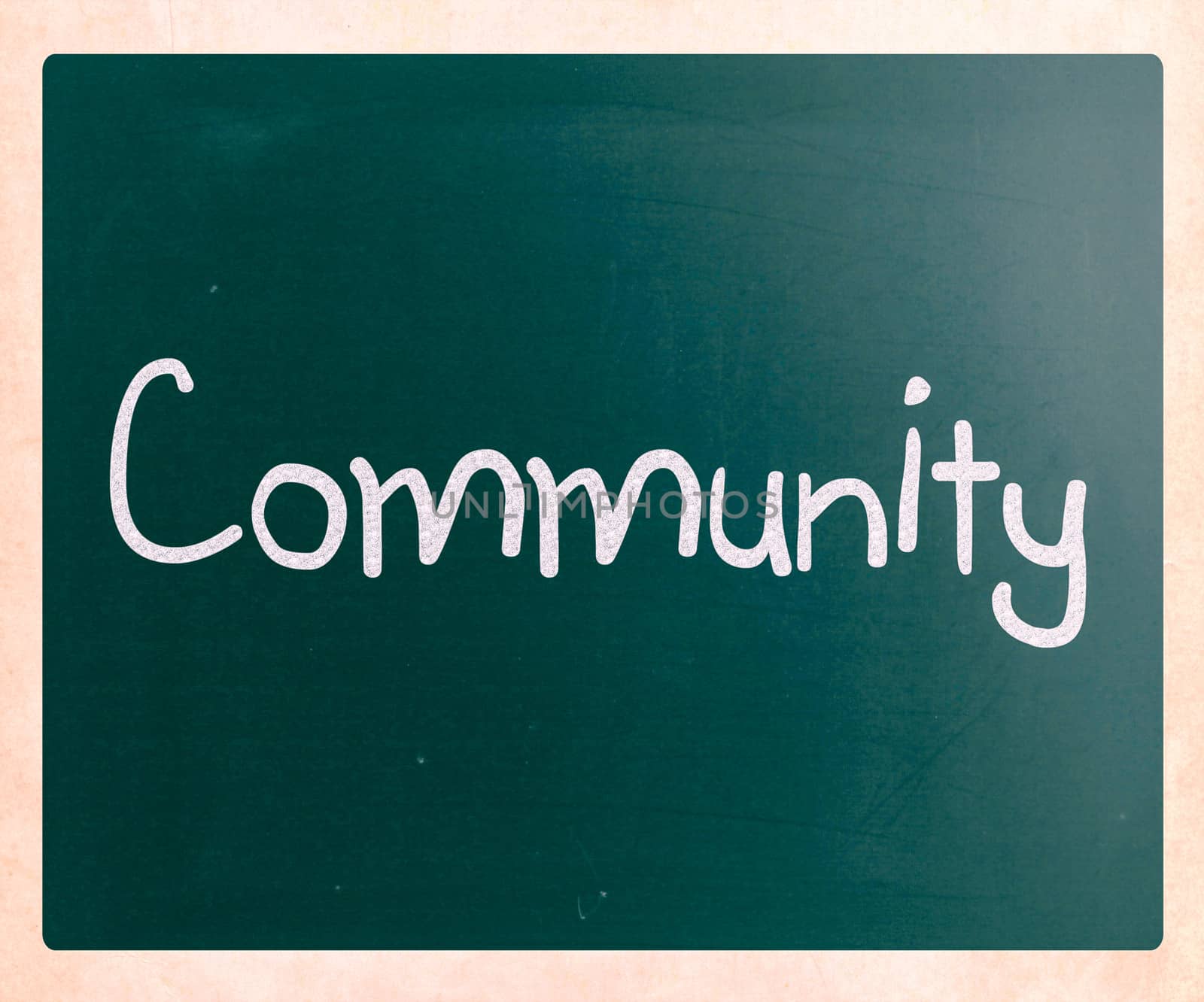 "Community" handwritten with white chalk on a blackboard