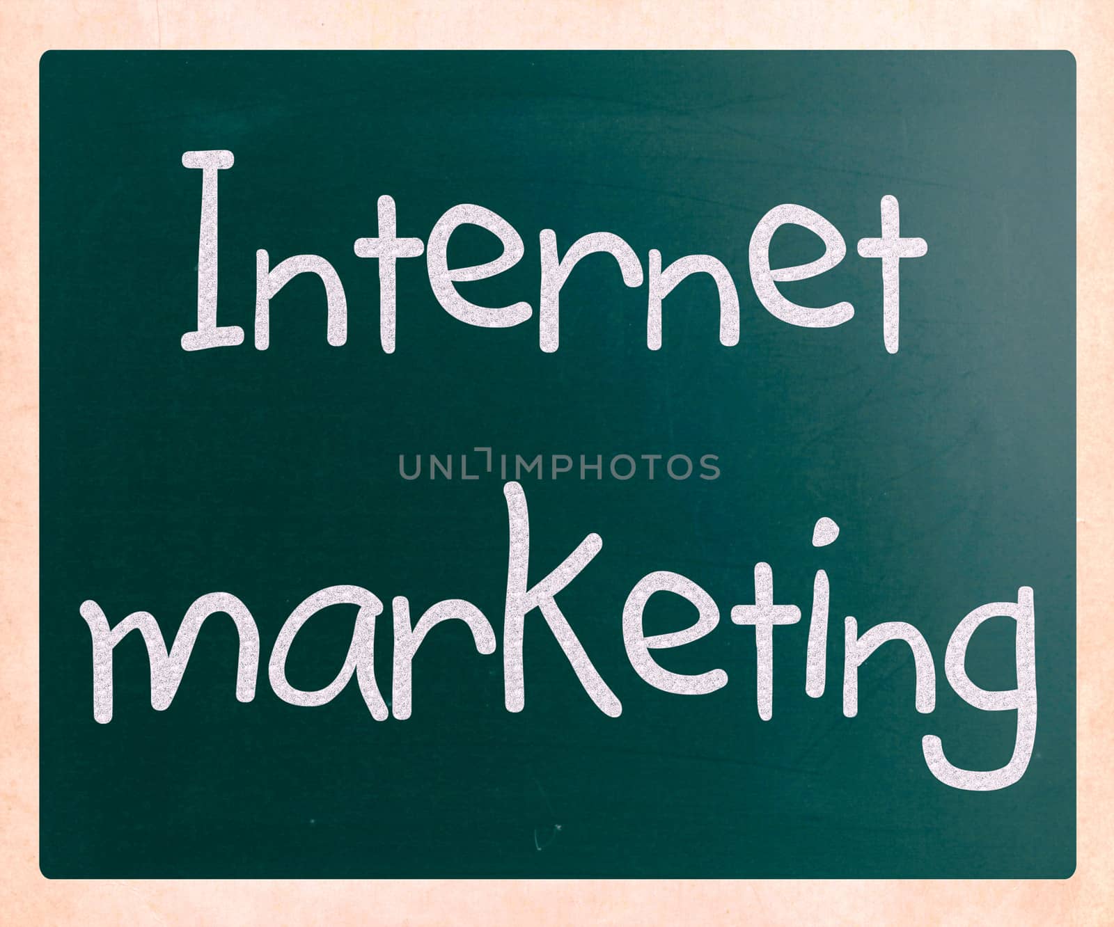 "Internet marketing" handwritten with white chalk on a blackboar by nenov