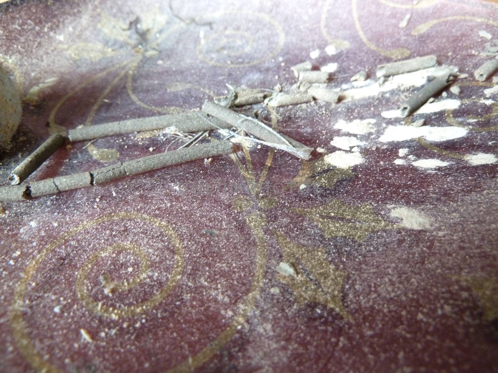 Grey ash on a tray after incense burning