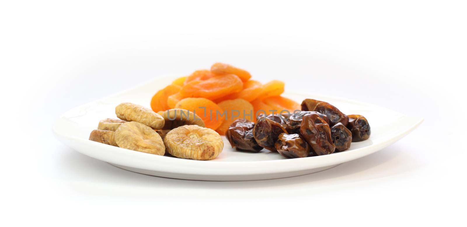 Dried fruits on a white plate