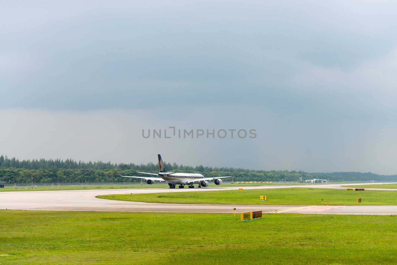 SINGAPORE - SEP 11: Singapore airlines plane speeds up on Changi airport runway on SEP 11, 2012  in Singapore. SIA is the flag carrier and 5-star airline of Singapore.