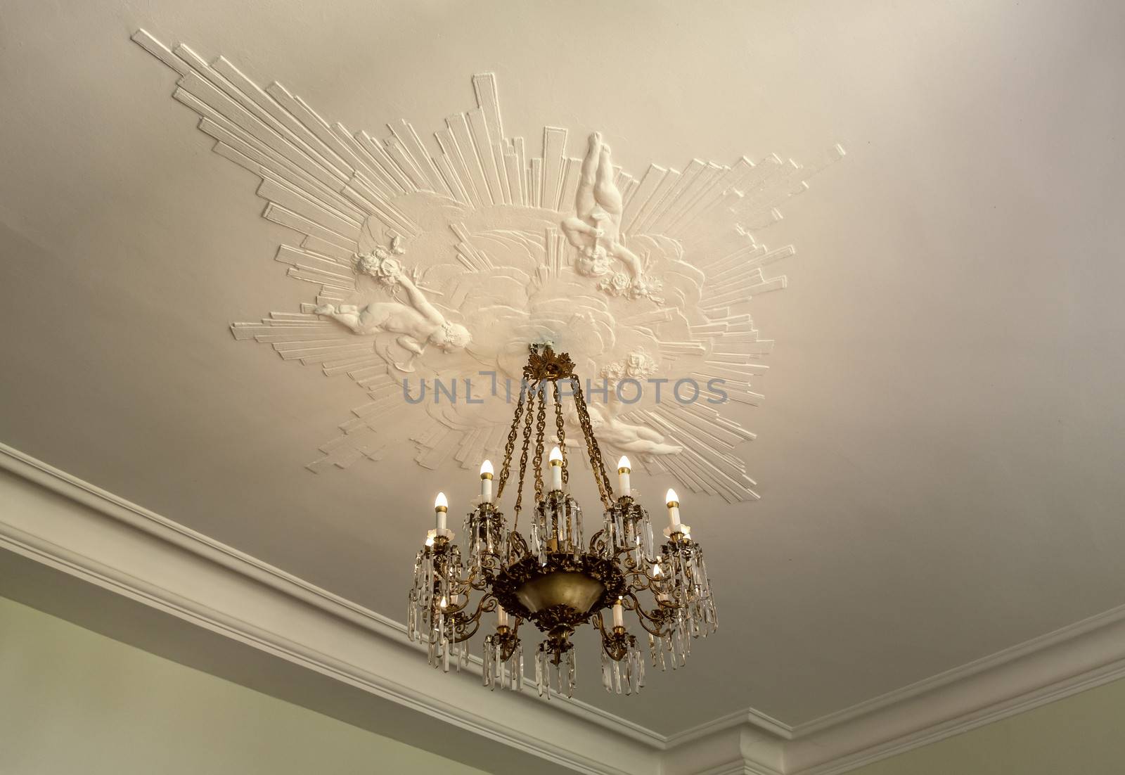 Nice vintage ceiling with old chandelier and beautiful artistic stucco.