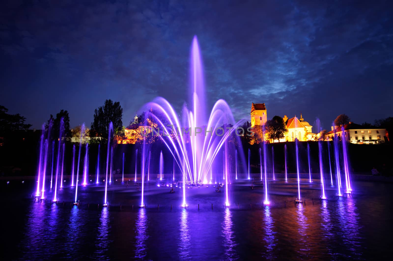 illuminated fountain at night in Warsaw. Poland by johnnychaos