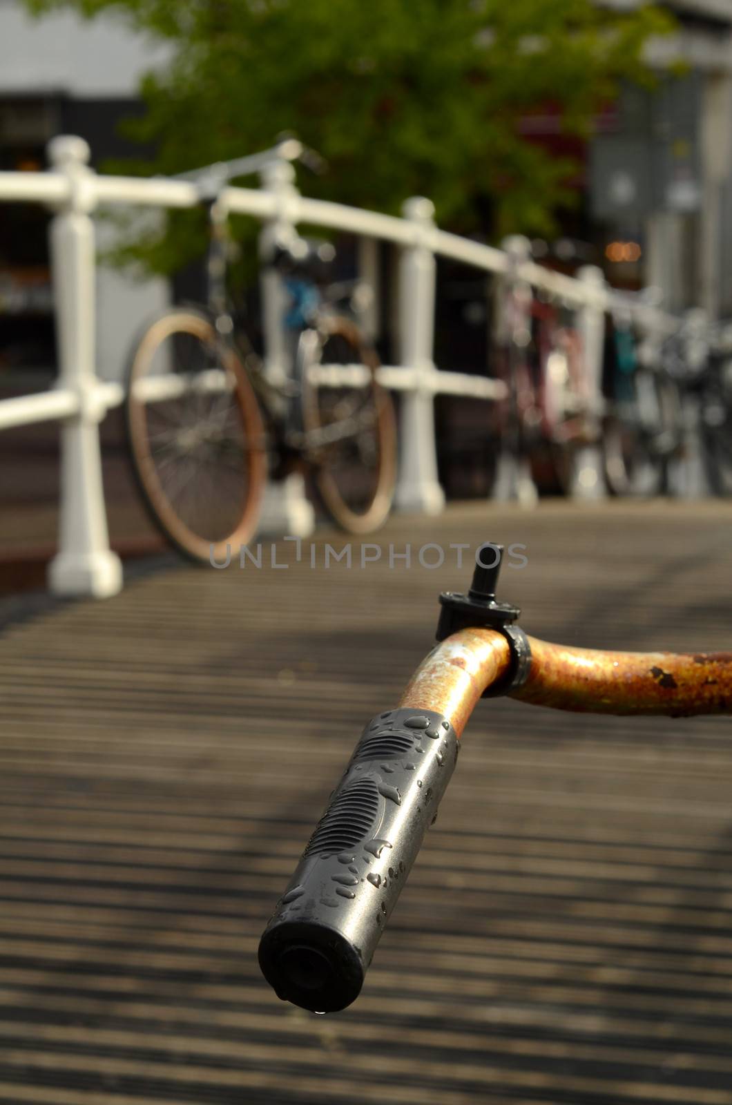Handlebar Of An Old Bike On A Bridge Over A Canal In The Netherlands
