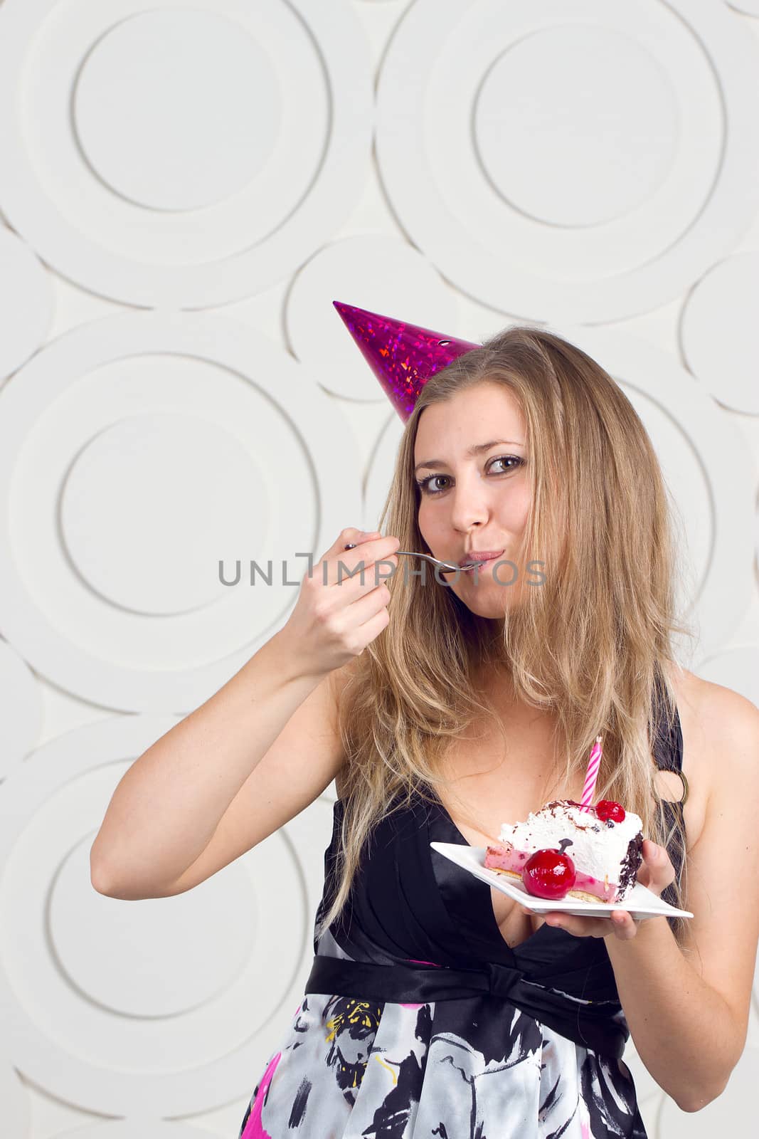 beautiful caucasian girl blowing candles on her cake